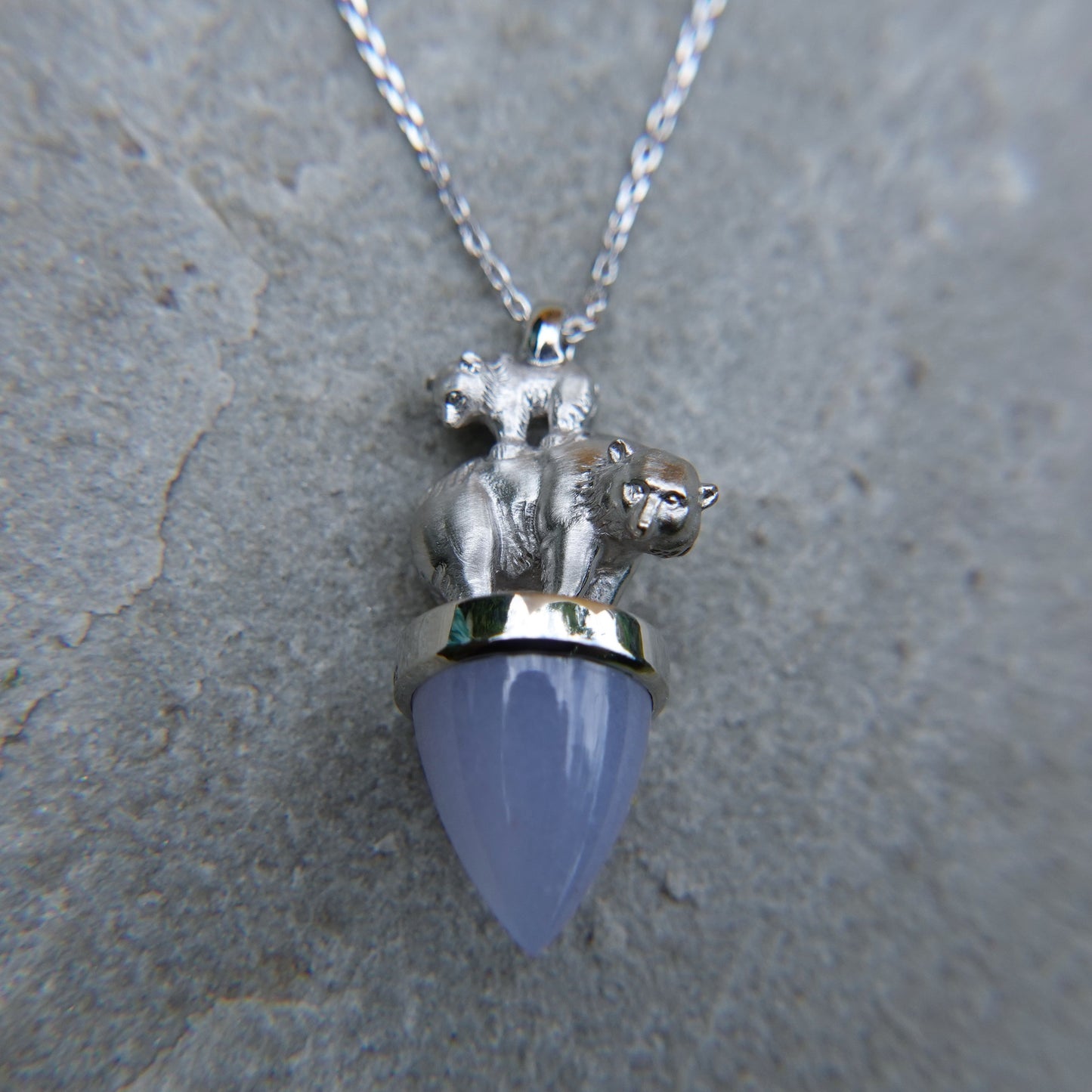Polar bear and child necklace. Solid white gold bears on a blue Chalcedony gemstone, with a white gold chain. *This piece is finished and ready to be shipped*