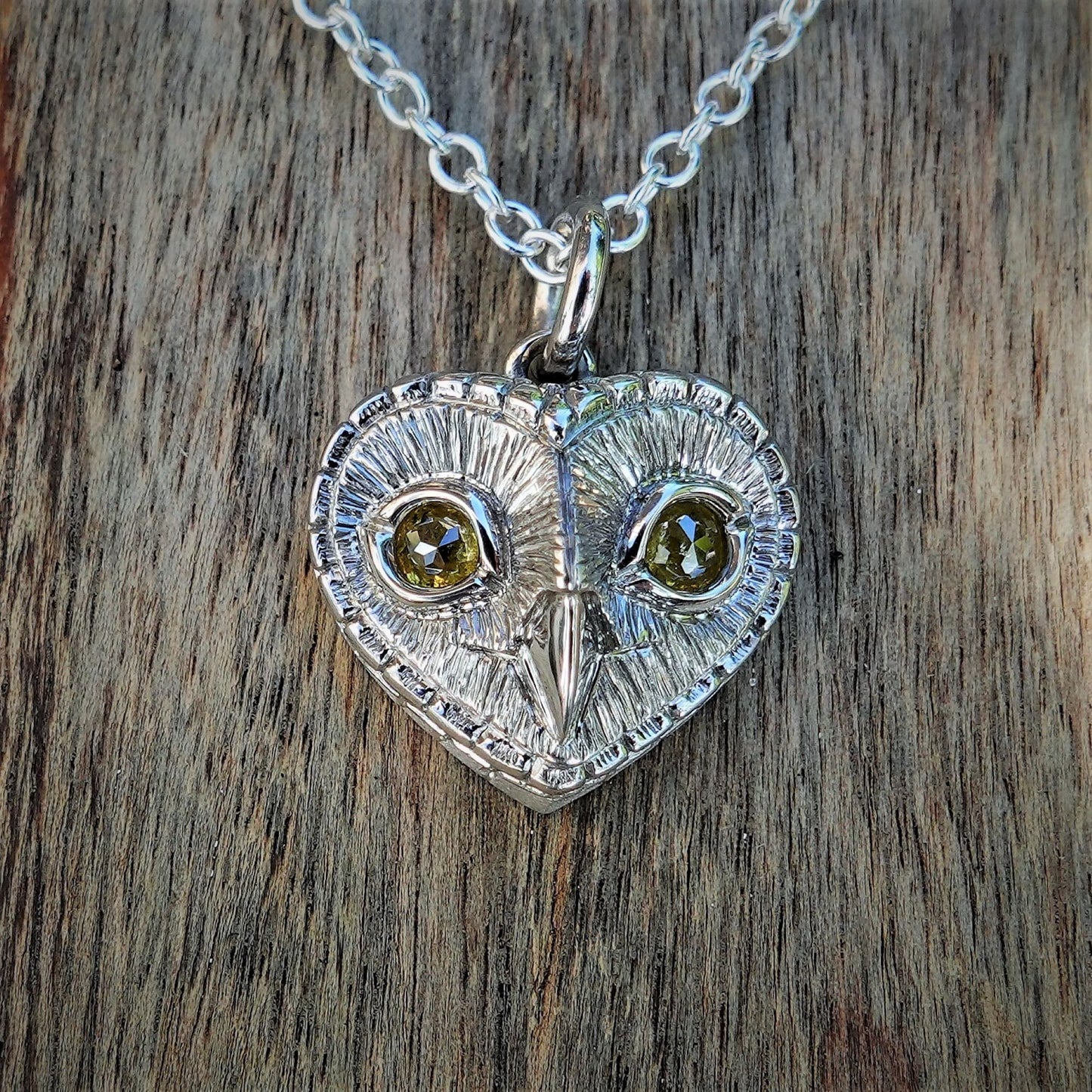 Diamond owl necklace. Platinum coated sterling silver owl pendant with natural, diamond eyes. © Adrian Ashley