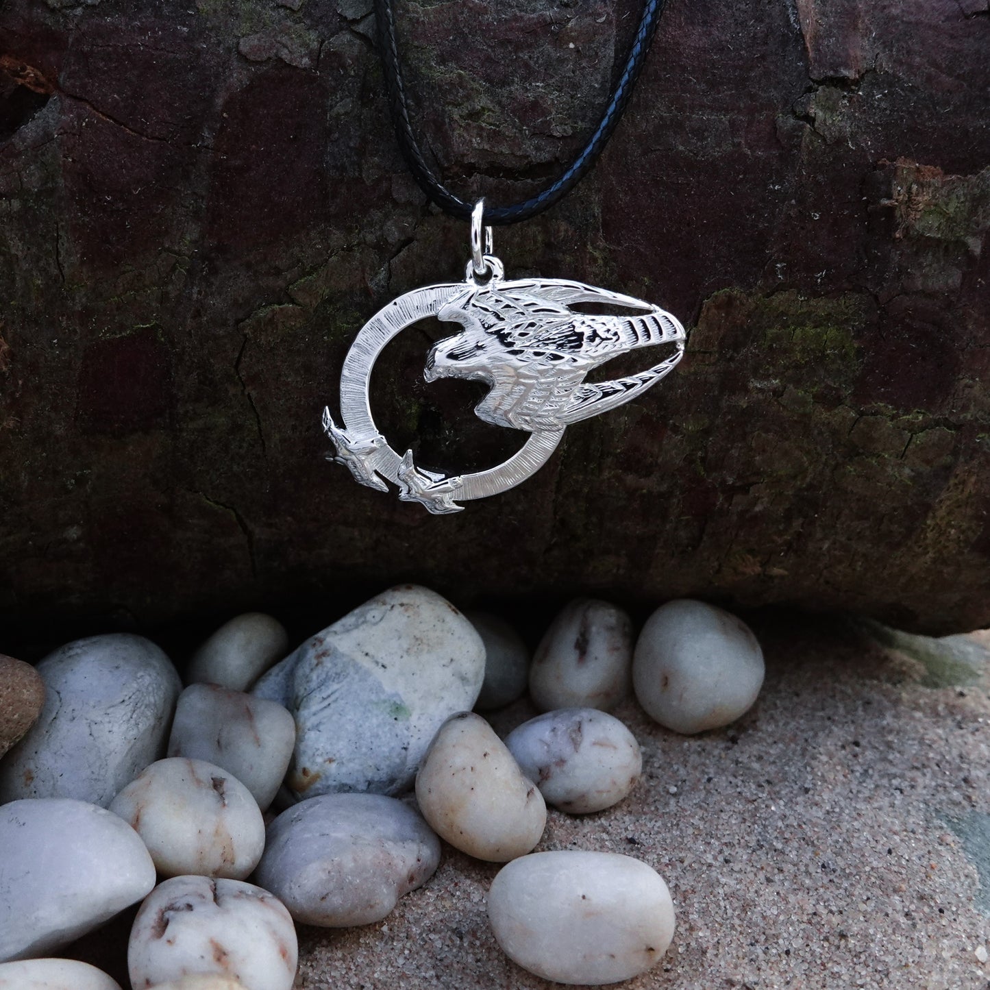 Falcon necklace. Made from highly polished, tarnish resistant silver, strung on a strong cord. © Adrian Ashley