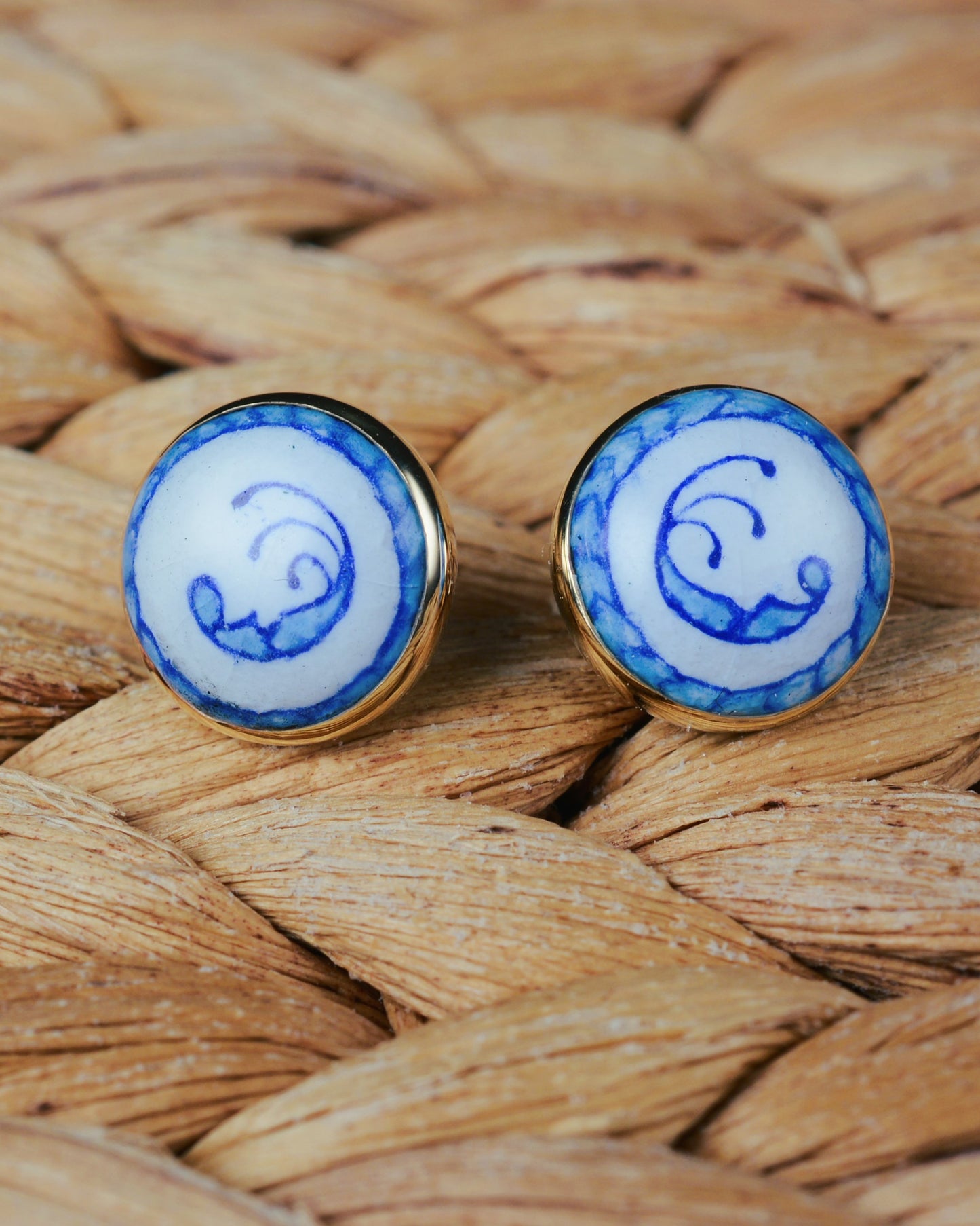 Enamelled gold and silver earrings with a blue motif.