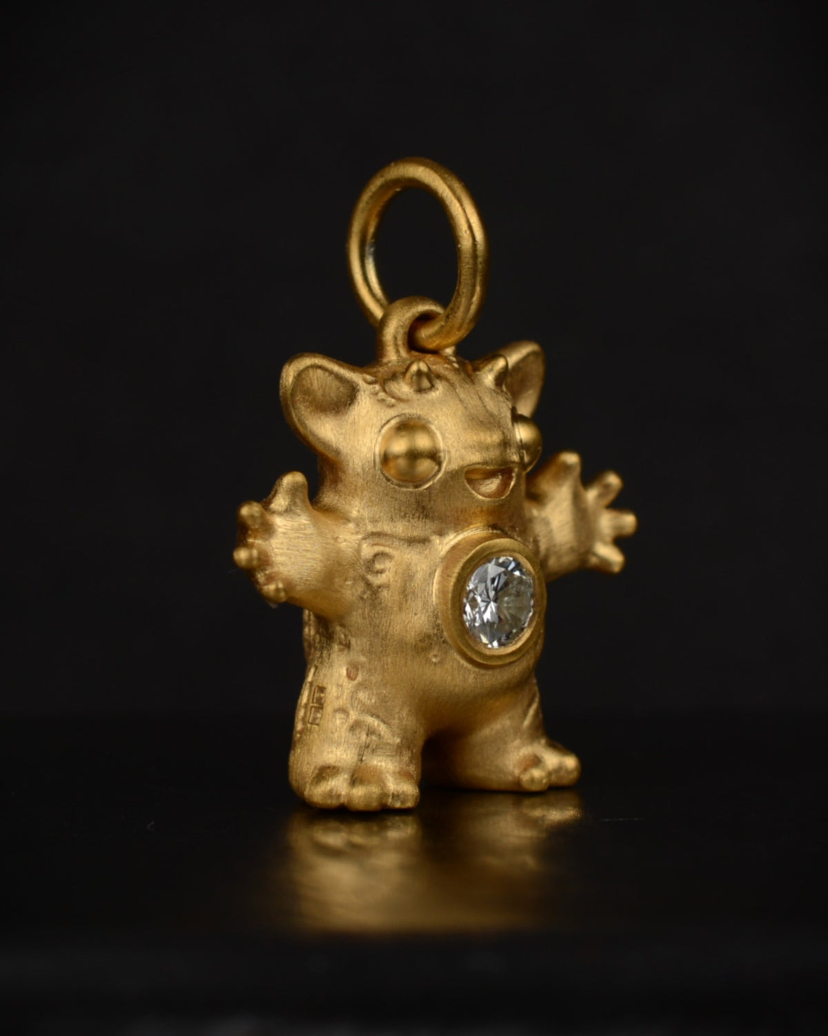 Satin finished vermeil Creature set with a natural diamond.