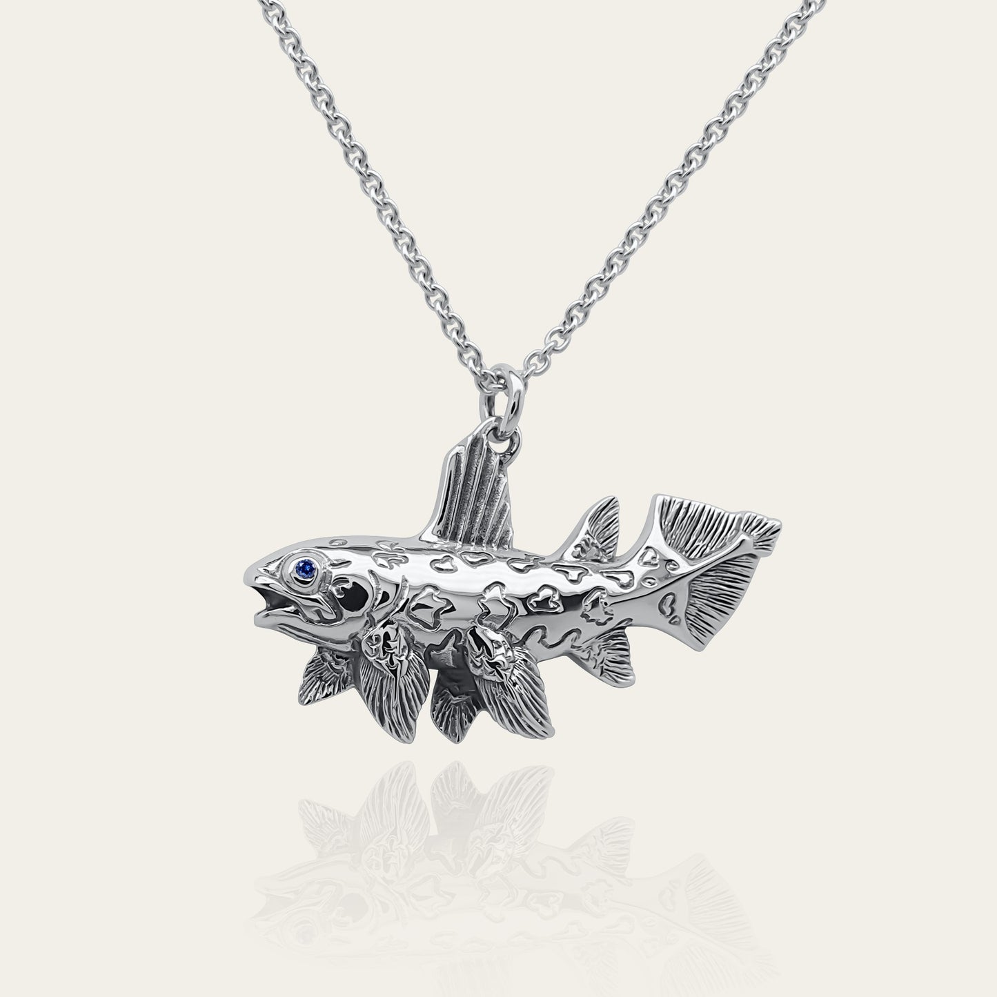 Coelacanth necklace. Made from sterling silver with an antiqued finish, set with a gemstone eye. Prehistoric fish pendant © Adrian Ashley