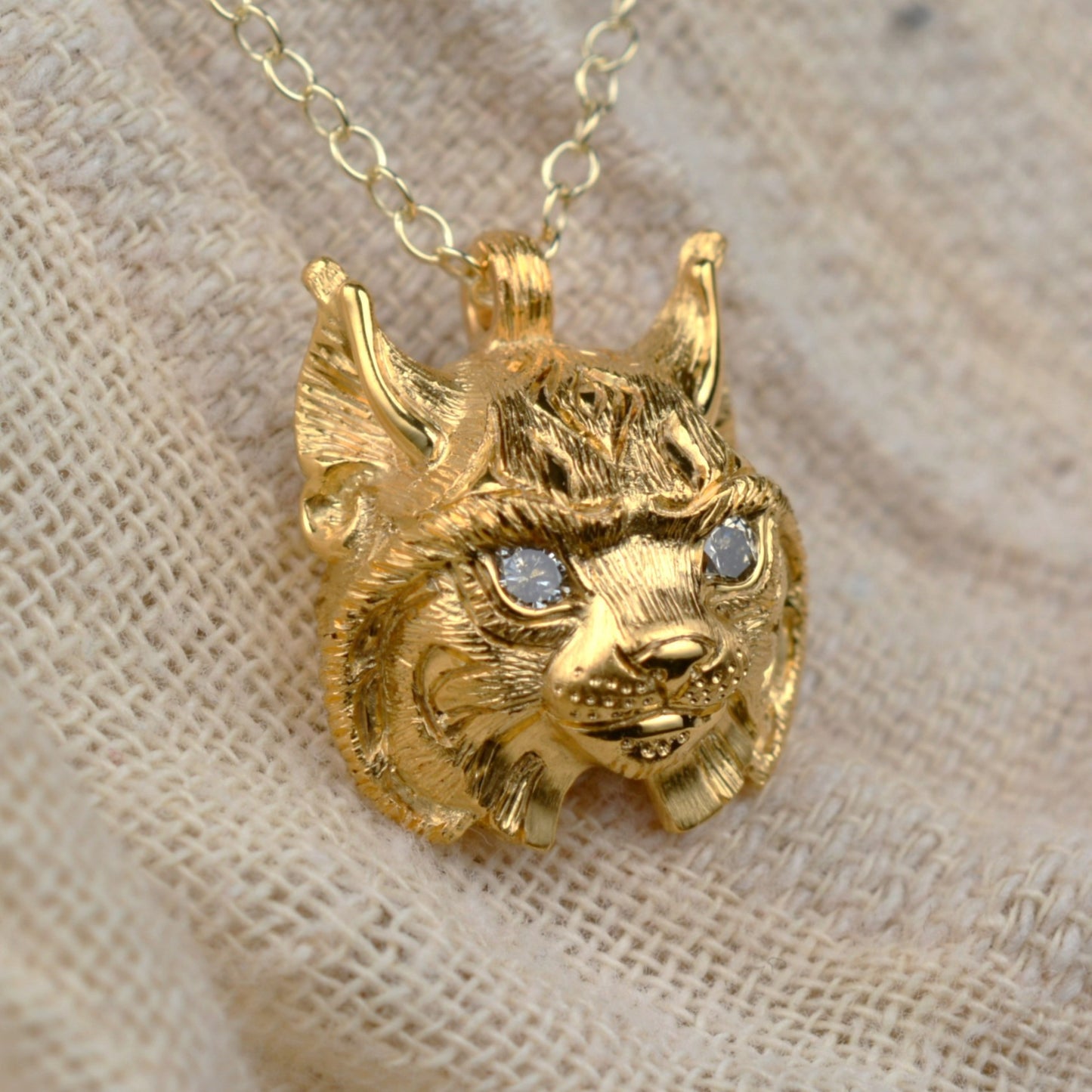 Gold lynx head pendant with diamond eyes and a gold chain. *This piece is finished and ready to be shipped* © Adrian Ashley