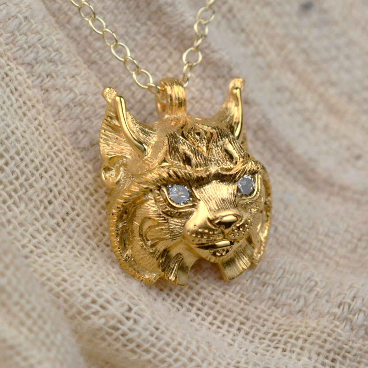 Gold lynx head pendant with diamond eyes and a gold chain. *This piece is finished and ready to be shipped*