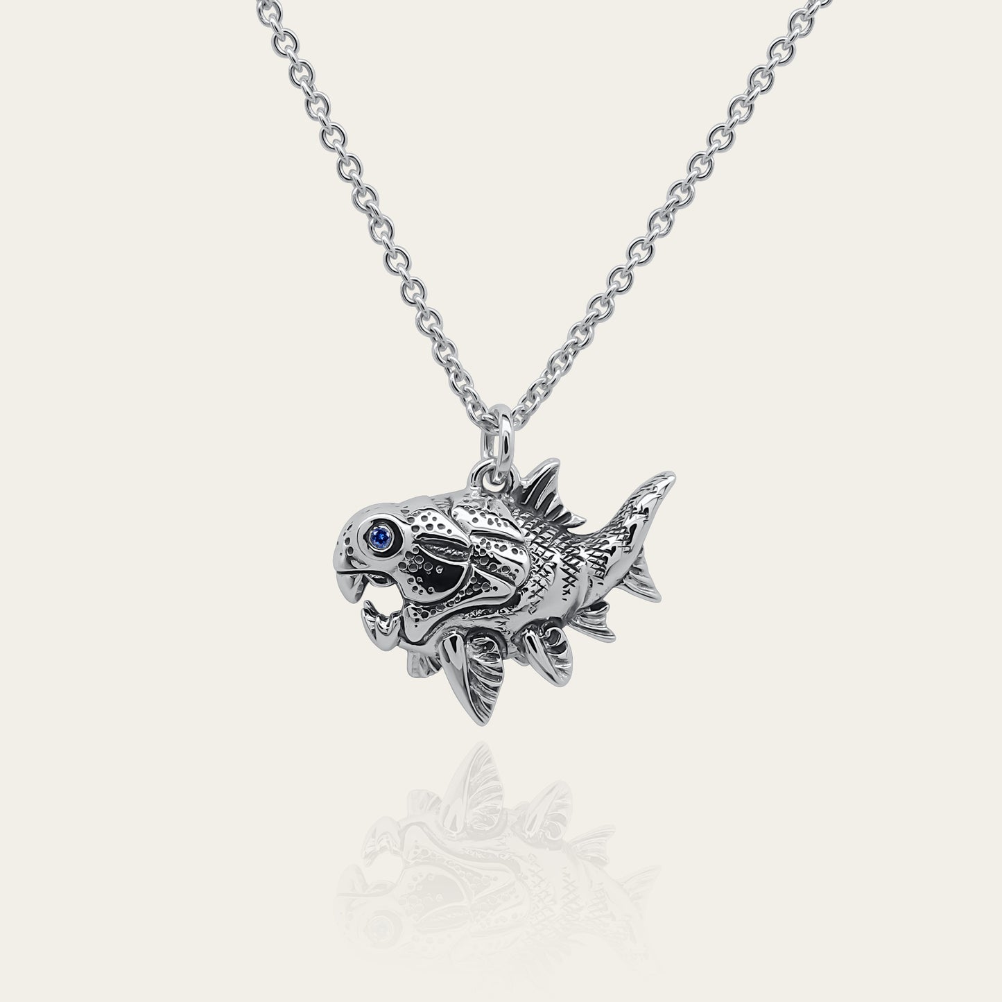Dunkleosteus necklace. Made from sterling silver with an antiqued finish, set with a gemstone eye. Prehistoric fish pendant © Adrian Ashley