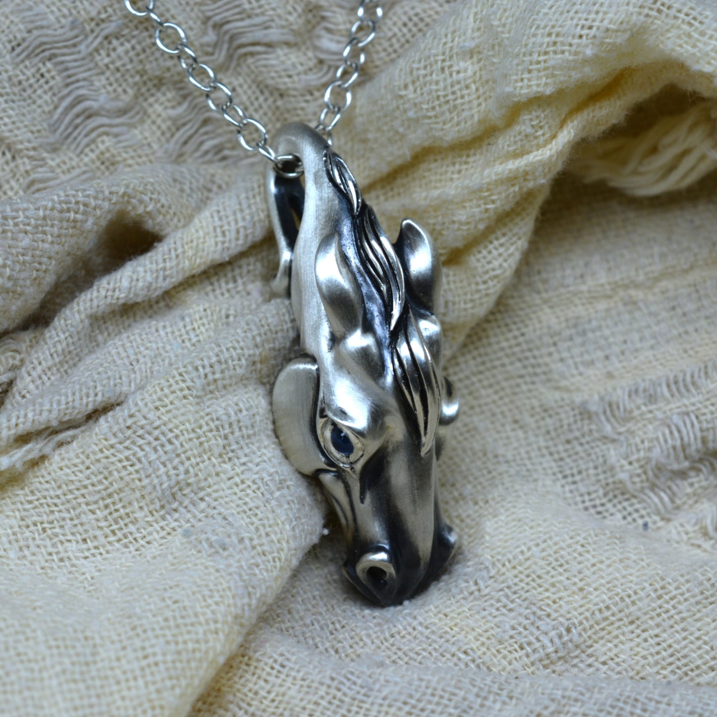 Sterling Silver horse head pendant with fine sapphire eyes. Ready to be shipped. © Adrian Ashley