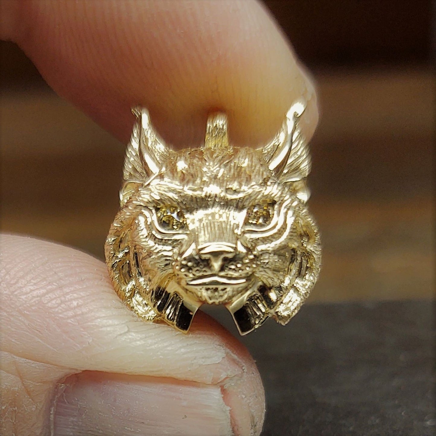 Gold lynx head pendant with diamond eyes and a gold chain. Handmade to order. © Adrian Ashley