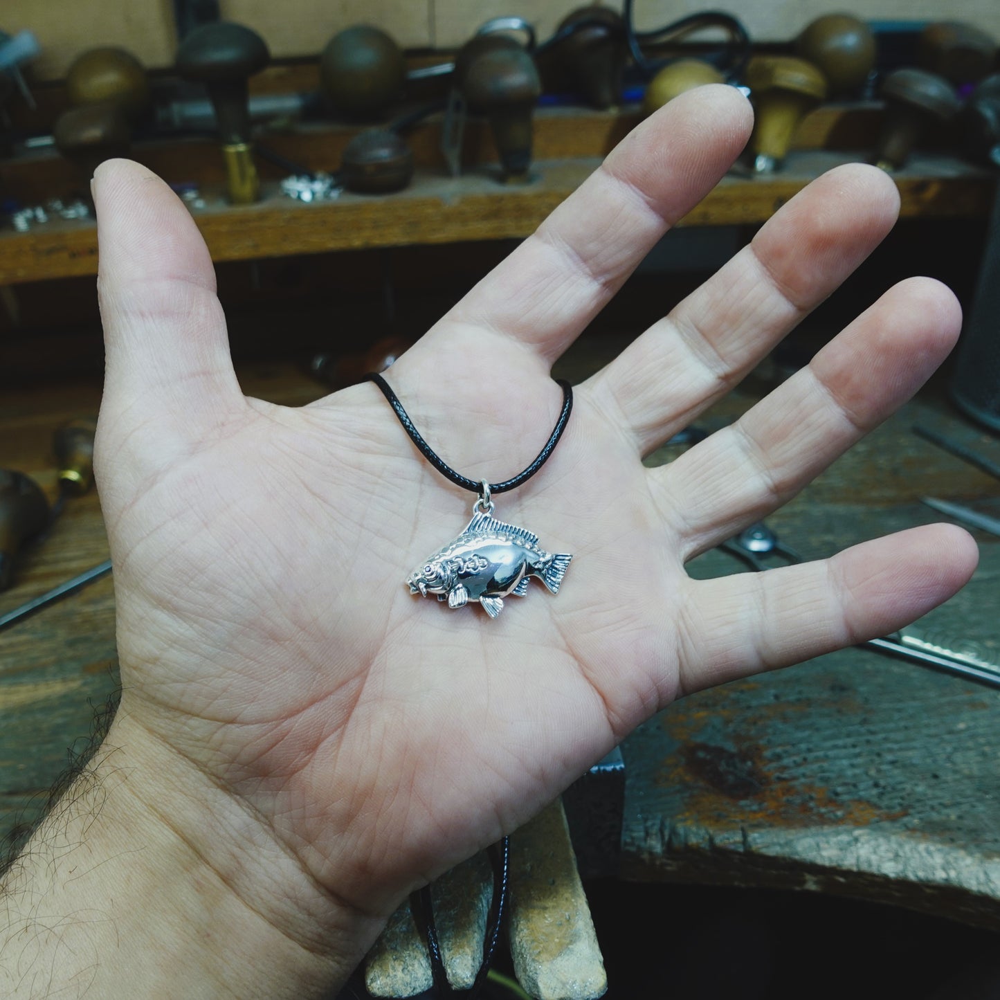 Mirror Carp fishing necklace. Made from sterling silver with an antiqued finish, set with a gemstone eye. Ideal fisherman’s angling gift © Adrian Ashley