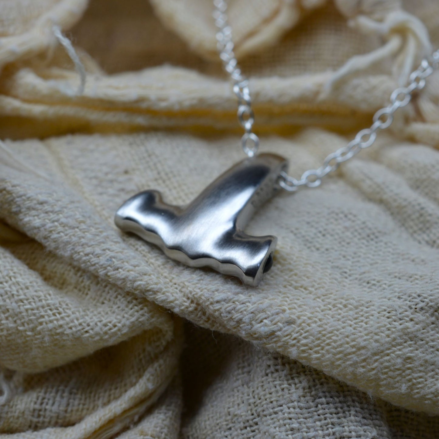 Platinum coated, solid silver Hammerhead Shark Mjölnir pendant with sapphire eyes — A refined interpretation of the beloved Norse Viking icon. © Adrian Ashley