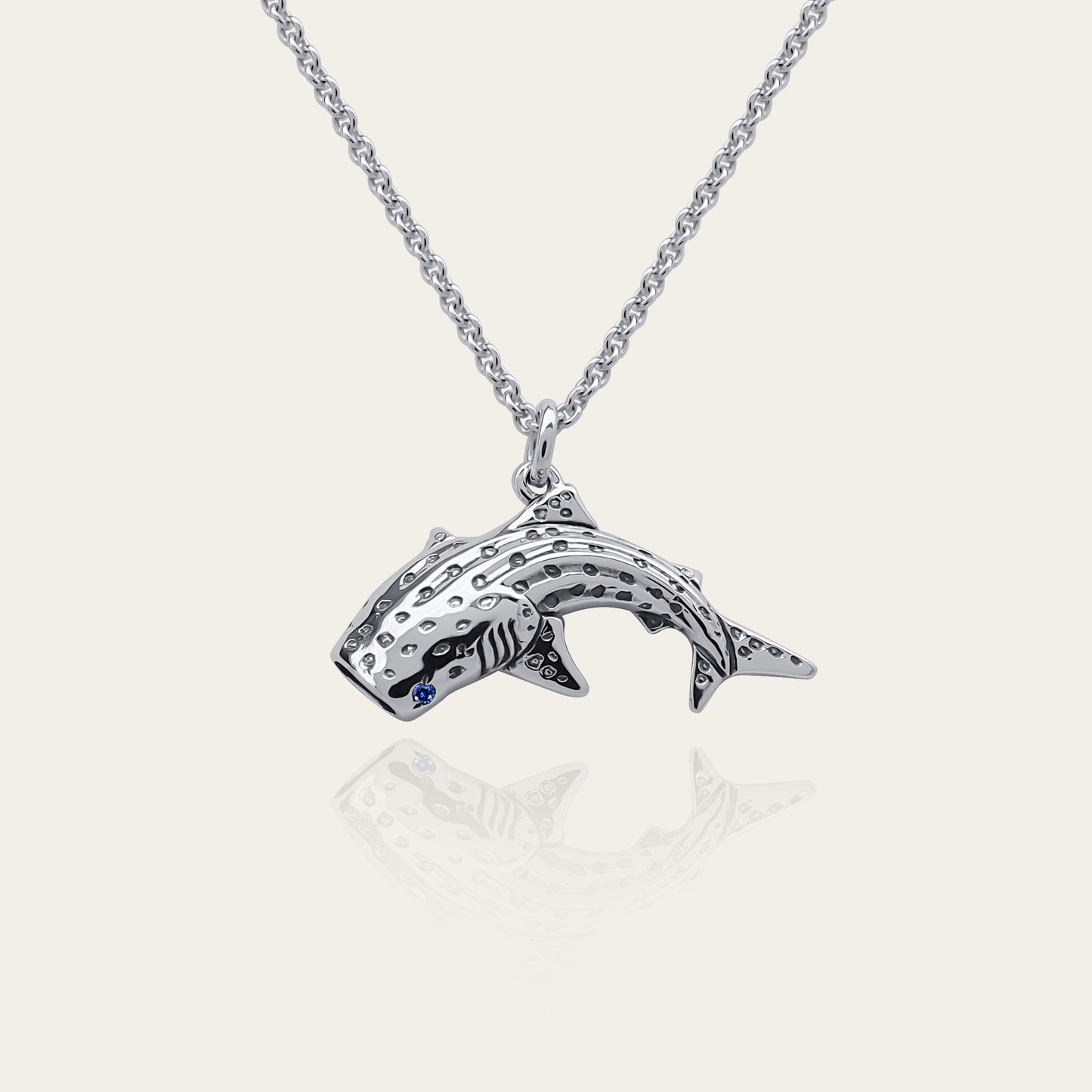 Whale shark necklace. Made from sterling silver with an antiqued finish, set with a gemstone eye. Diver's pendant © Adrian Ashley