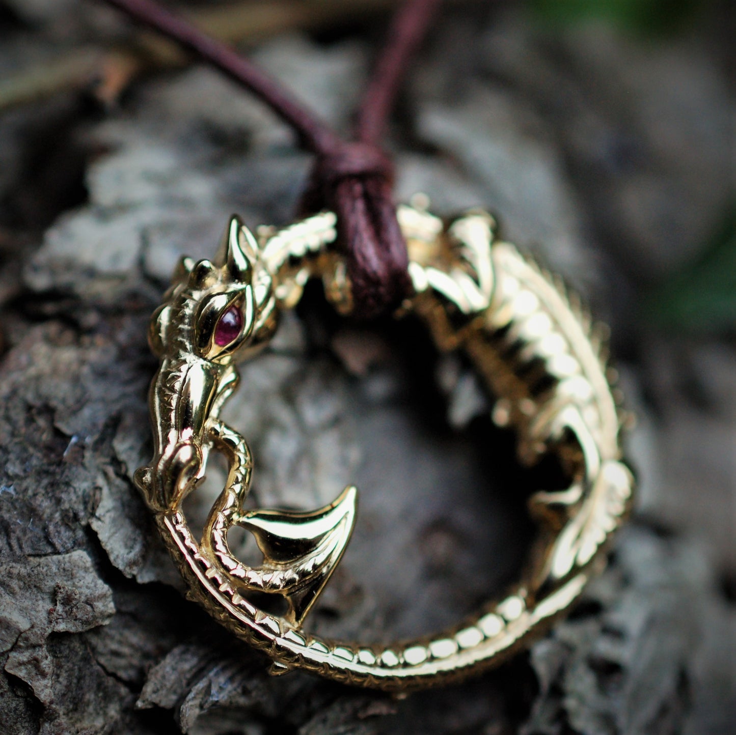Mid-sized ouroboros dragon pendant. Gold dragon necklace with a ruby eye. Hand made to order. © Adrian Ashley