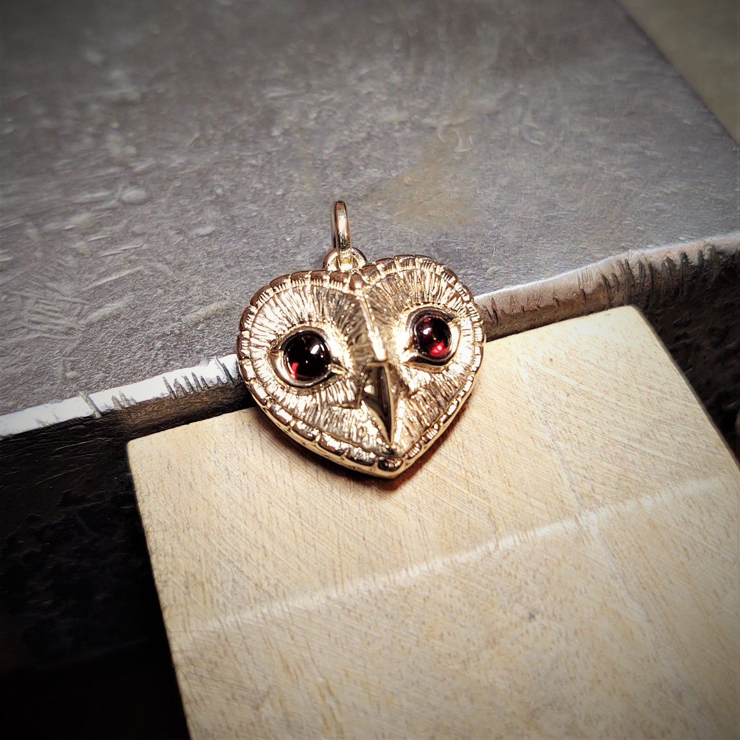 Gold owl necklace. Gold and garnet, heart shaped owl pendant. Hand made to order. © Adrian Ashley