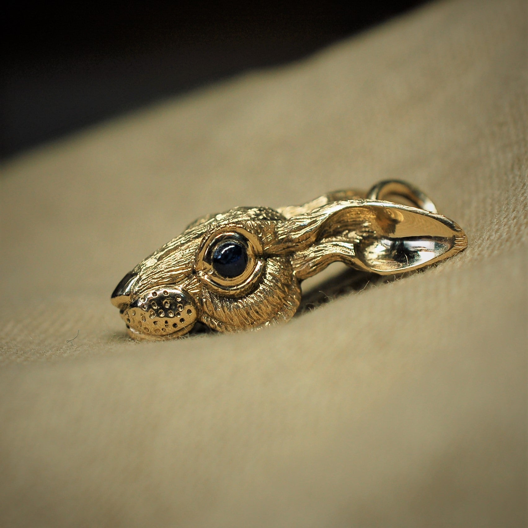 Gold rabbit Hare pendant with sapphire eyes and a gold