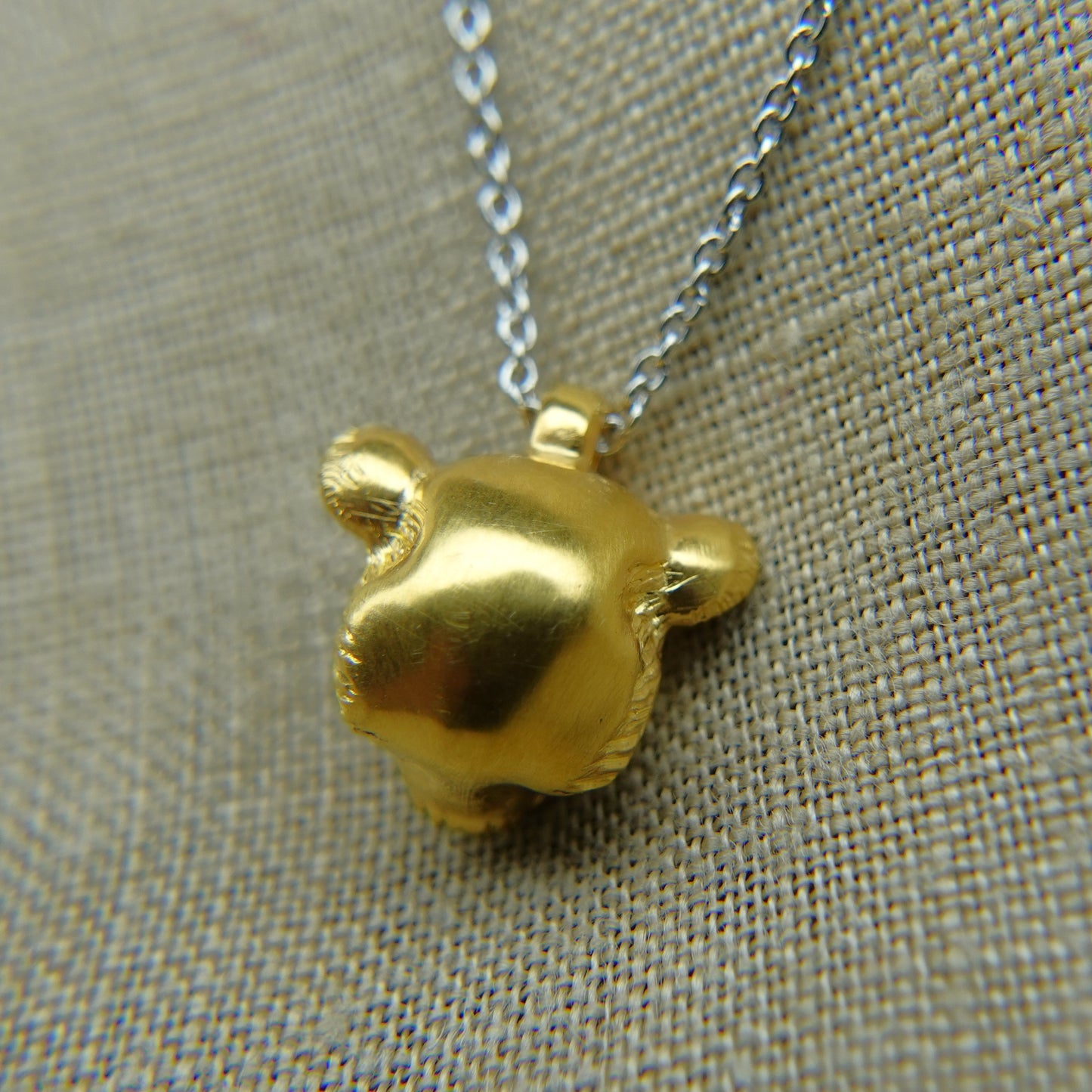 Solid 22ct gold lioness pendant and platinum chain. Handmade to order. © Adrian Ashley