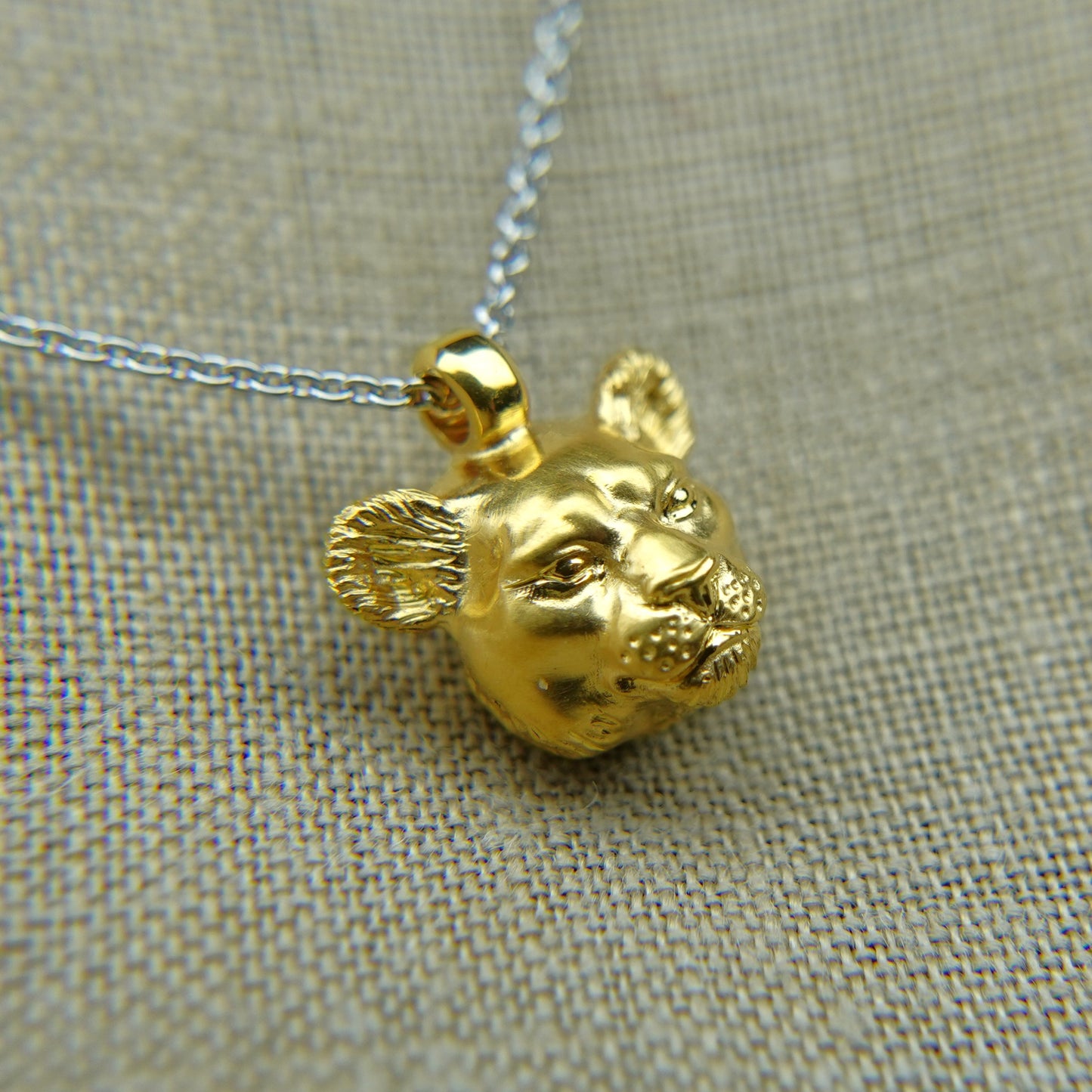 Solid 22ct gold lioness pendant and platinum chain. Handmade to order. © Adrian Ashley