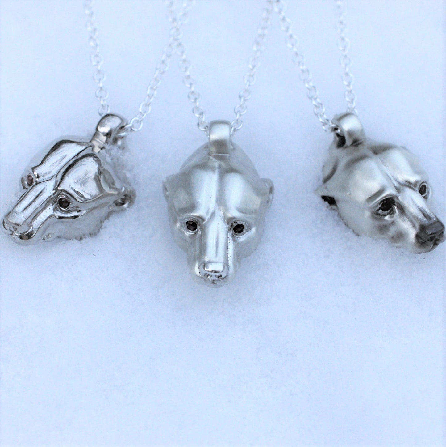 Platinum plated silver polar bear pendant and chain. Greenland ruby eyes. © Adrian Ashley