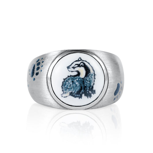Silver ring with a circular emblem featuring a badger design on a white background