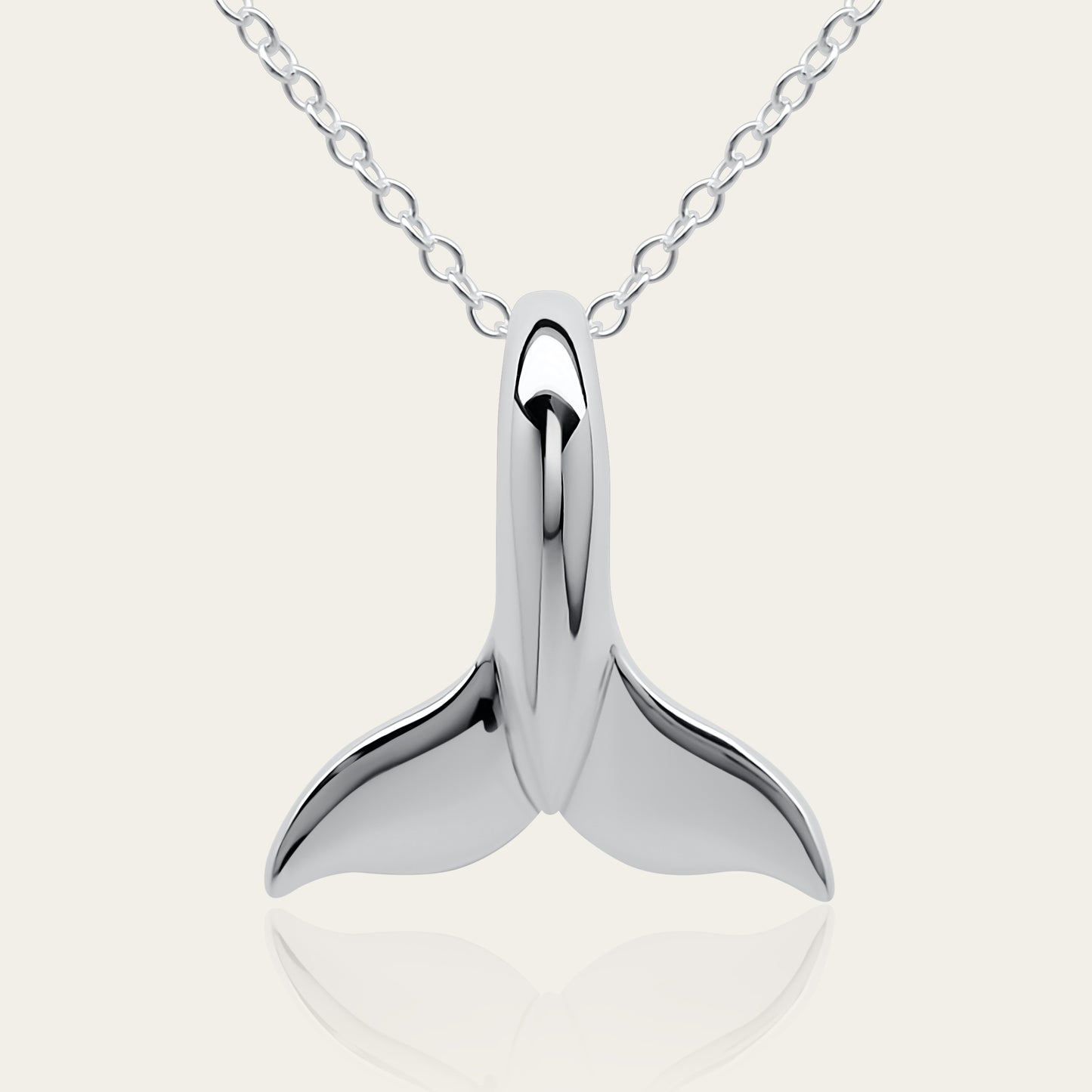 Classic whale tail necklace. Made from highly polished, tarnish resistant silver, hung on a solid silver chain. © Adrian Ashley