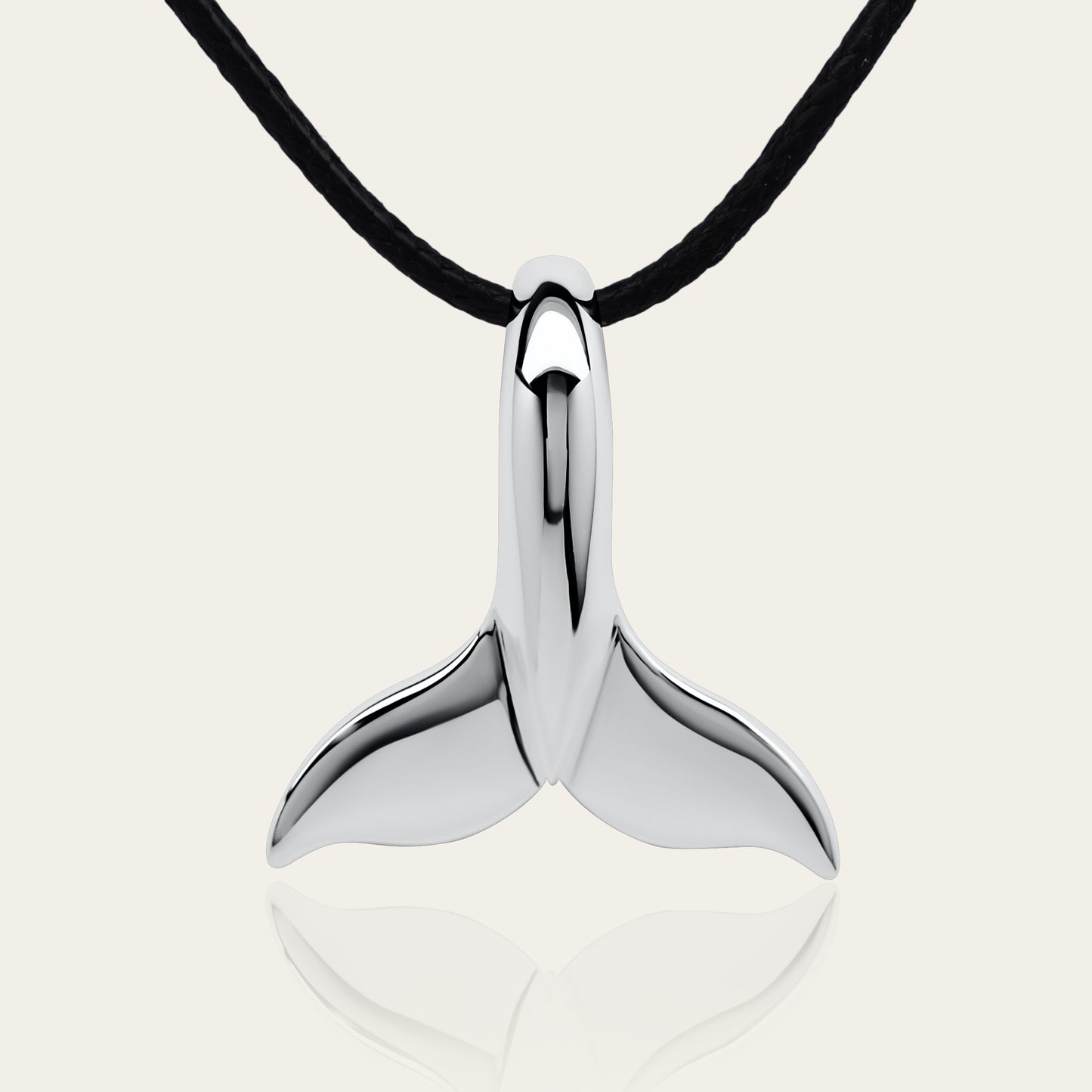 Classic whale tail necklace. Made from highly polished, tarnish resistant silver, strung on a strong cord. © Adrian Ashley