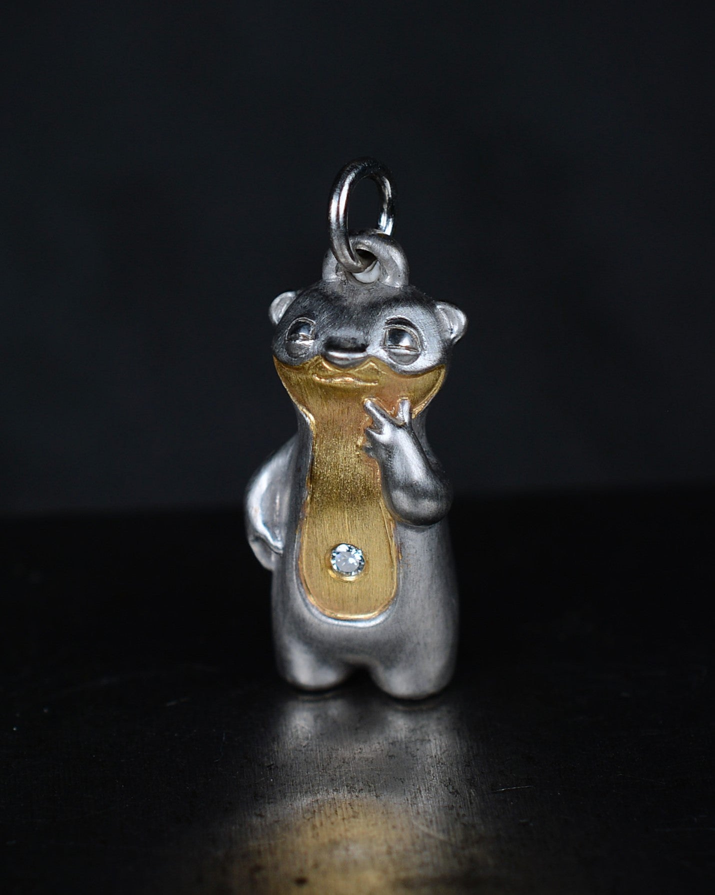 Contemplative Stoat type Bright Creature with a diamond and parcel gilt.
