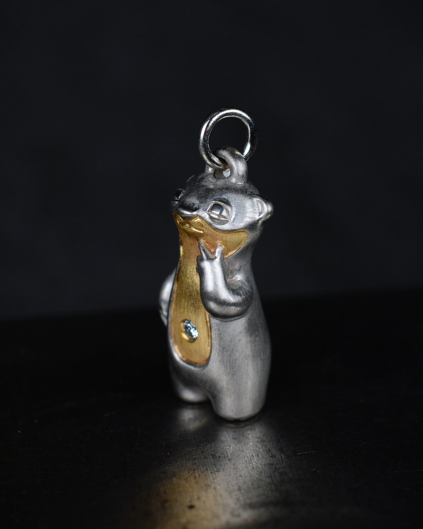 Contemplative Stoat type Bright Creature with a diamond and parcel gilt.