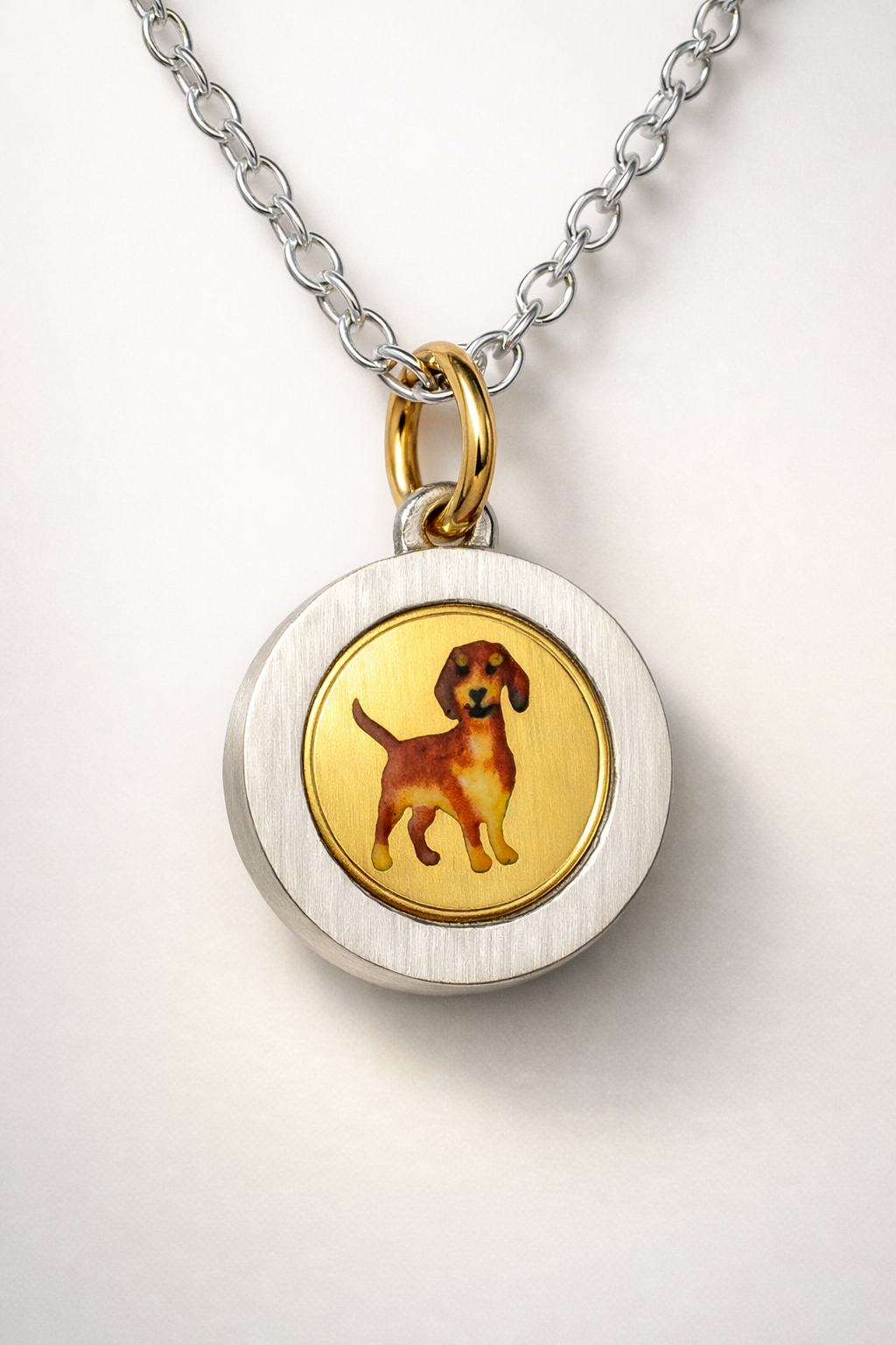 Enamel Dachshund on an 18ct gold disk in a silver pendant mount