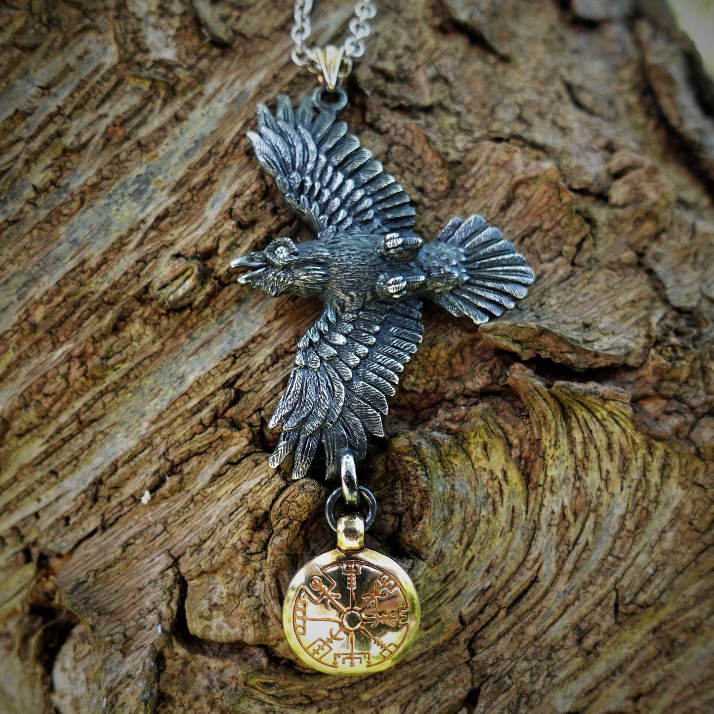 Blackened silver raven necklace, solid silver with diamond eyes, a yellow gold bail and a solid gold Vegvisir hung beneath it. *This piece is finished and ready to be shipped.*