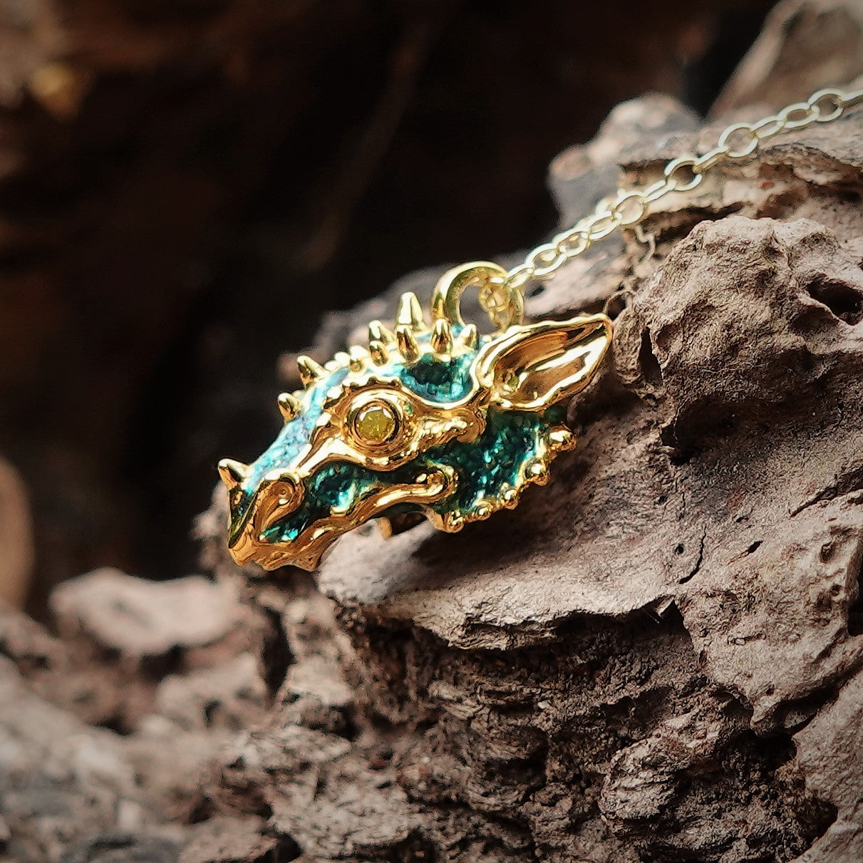 Gold dragon's head with diamond eyes and a gold chain. *This piece is finished and ready to be shipped* © Adrian Ashley