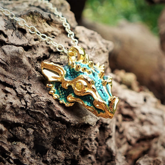 Gold dragon's head with diamond eyes and a gold chain. Handmade to order. © Adrian Ashley