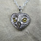 Diamond owl necklace. Platinum coated sterling silver heart shaped owl head pendant with natural, rose cut, diamond eyes © Adrian Ashley