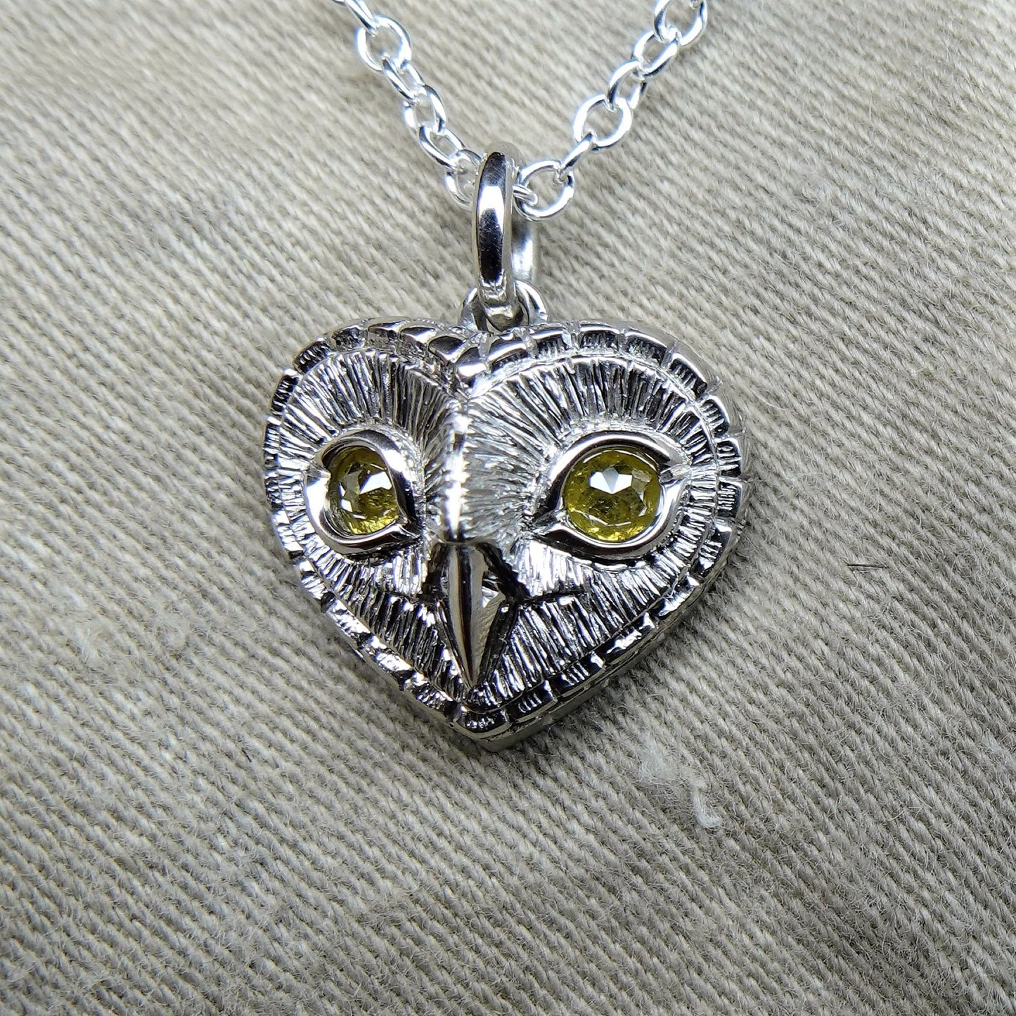 Diamond owl necklace. Platinum coated sterling silver heart shaped owl head pendant with natural, rose cut, diamond eyes © Adrian Ashley