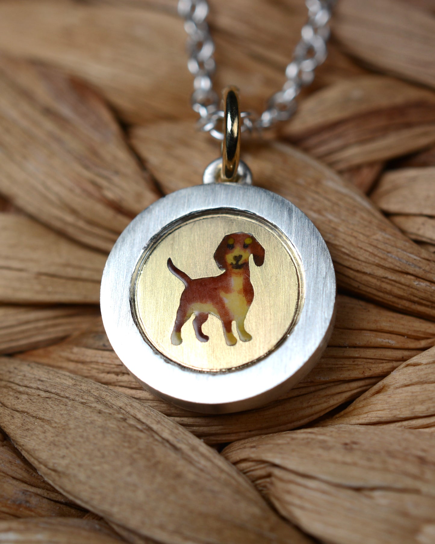 Enamel Dachshund on an 18ct gold disk in a silver pendant mount