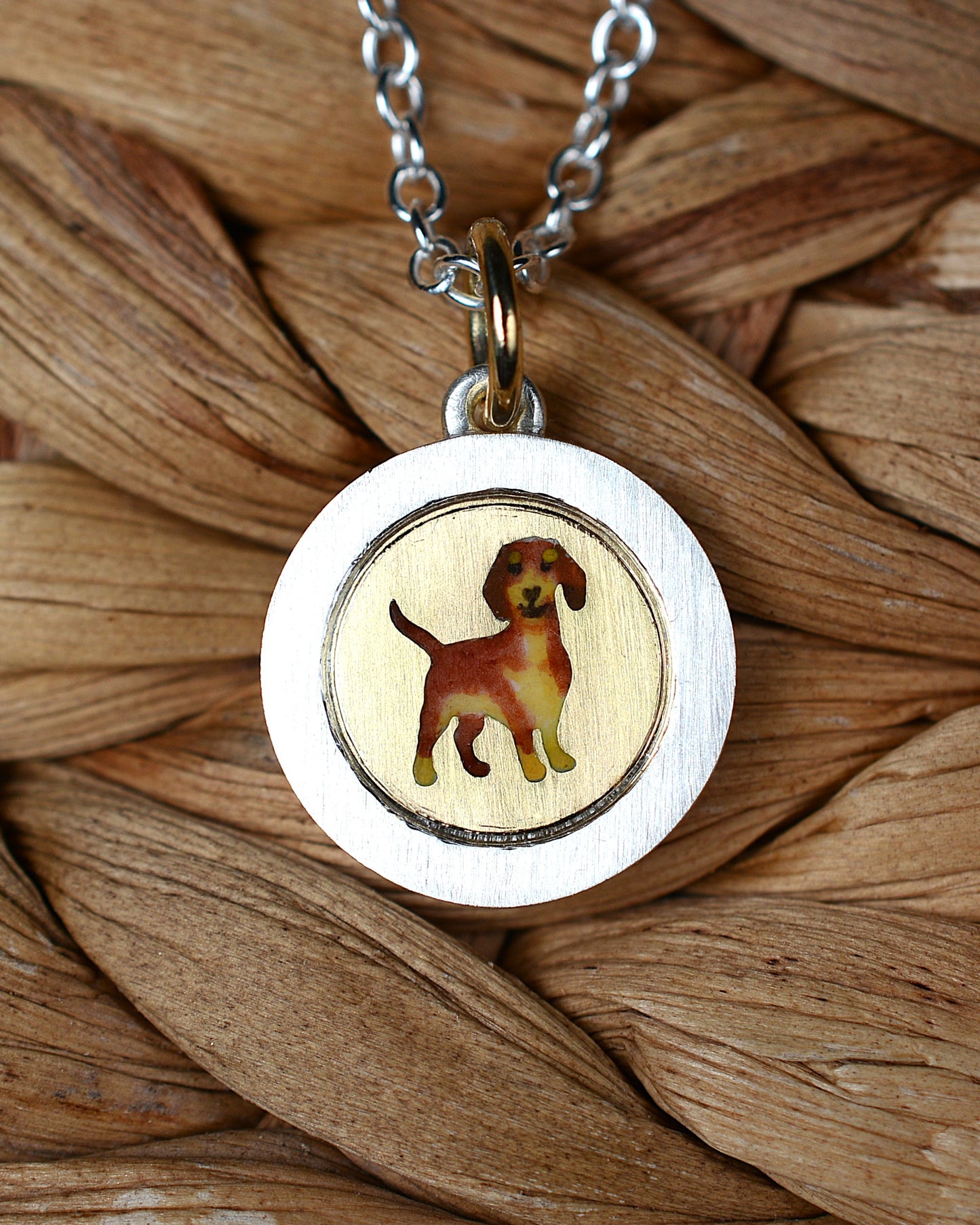 Enamel Dachshund on an 18ct gold disk in a silver pendant mount