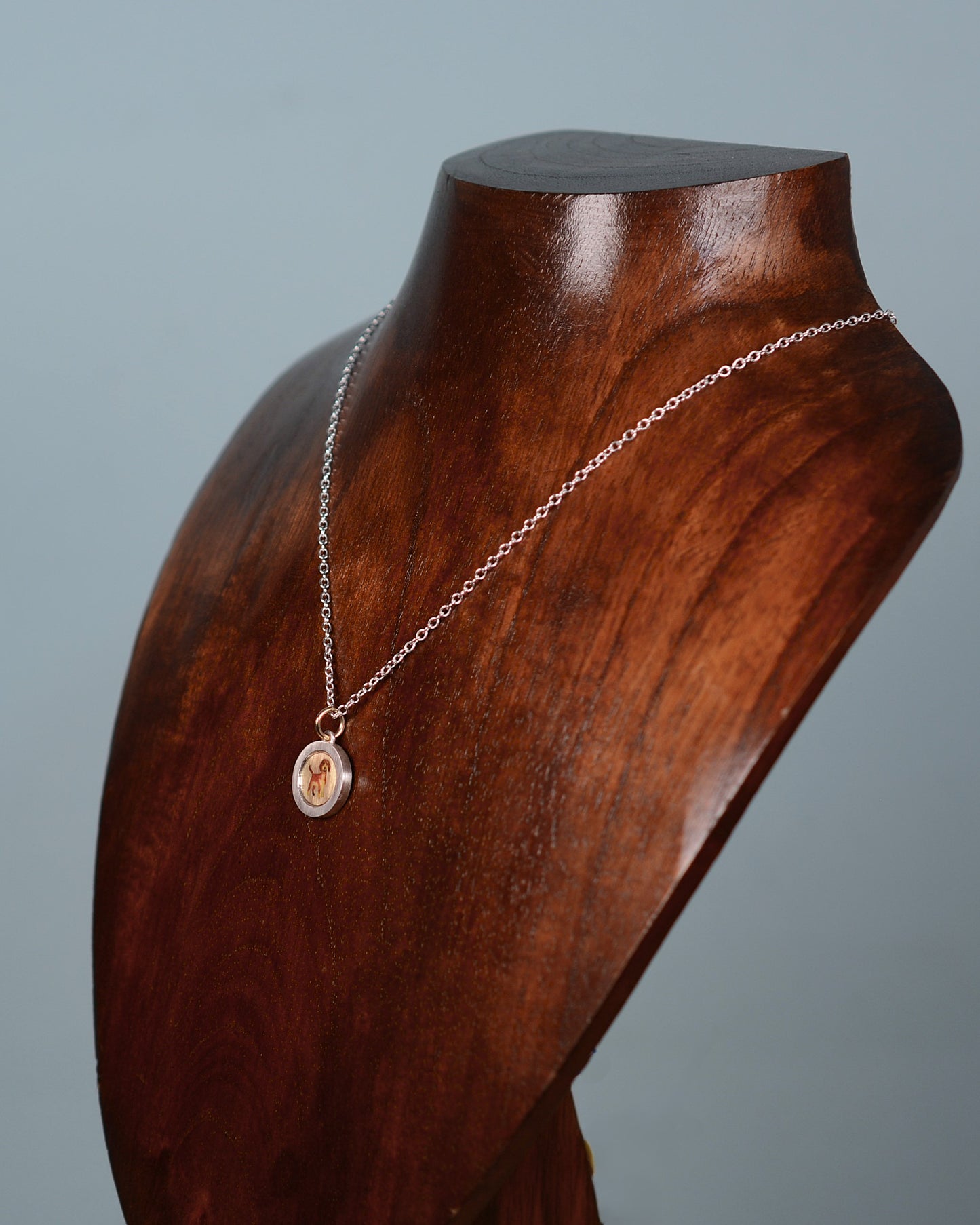Enamel Dachshund on an 18ct gold disk in a silver pendant mount