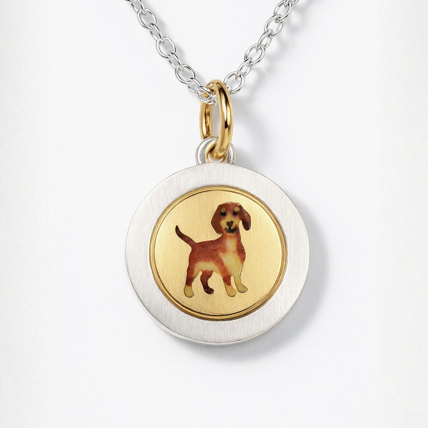 Enamel Dachshund on an 18ct gold disk in a silver pendant mount