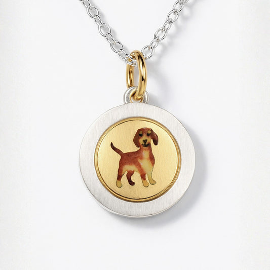 Enamel Dachshund on an 18ct gold disk in a silver pendant mount