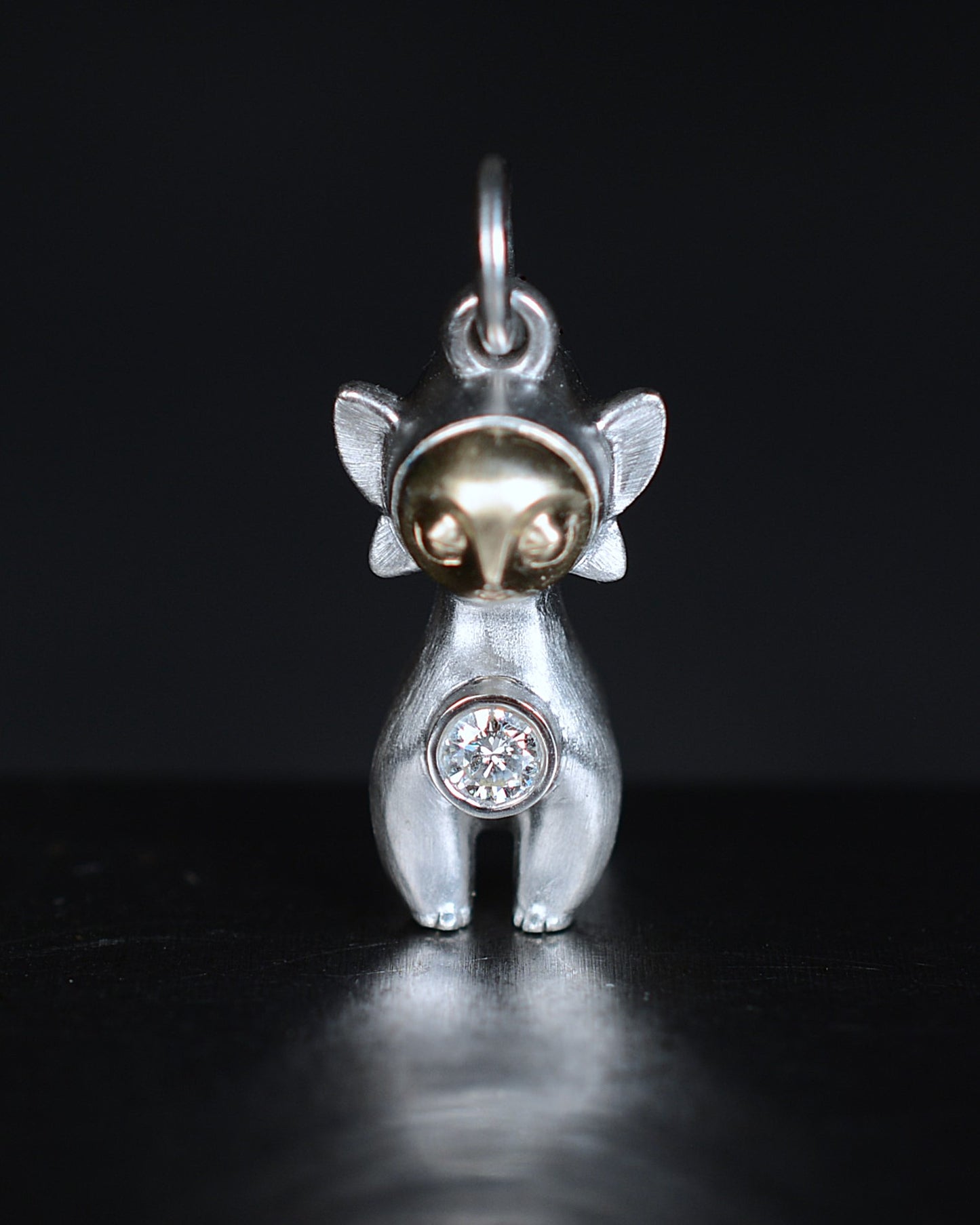 Art Deco Bright Creature with a gold face, set with a natural diamond.