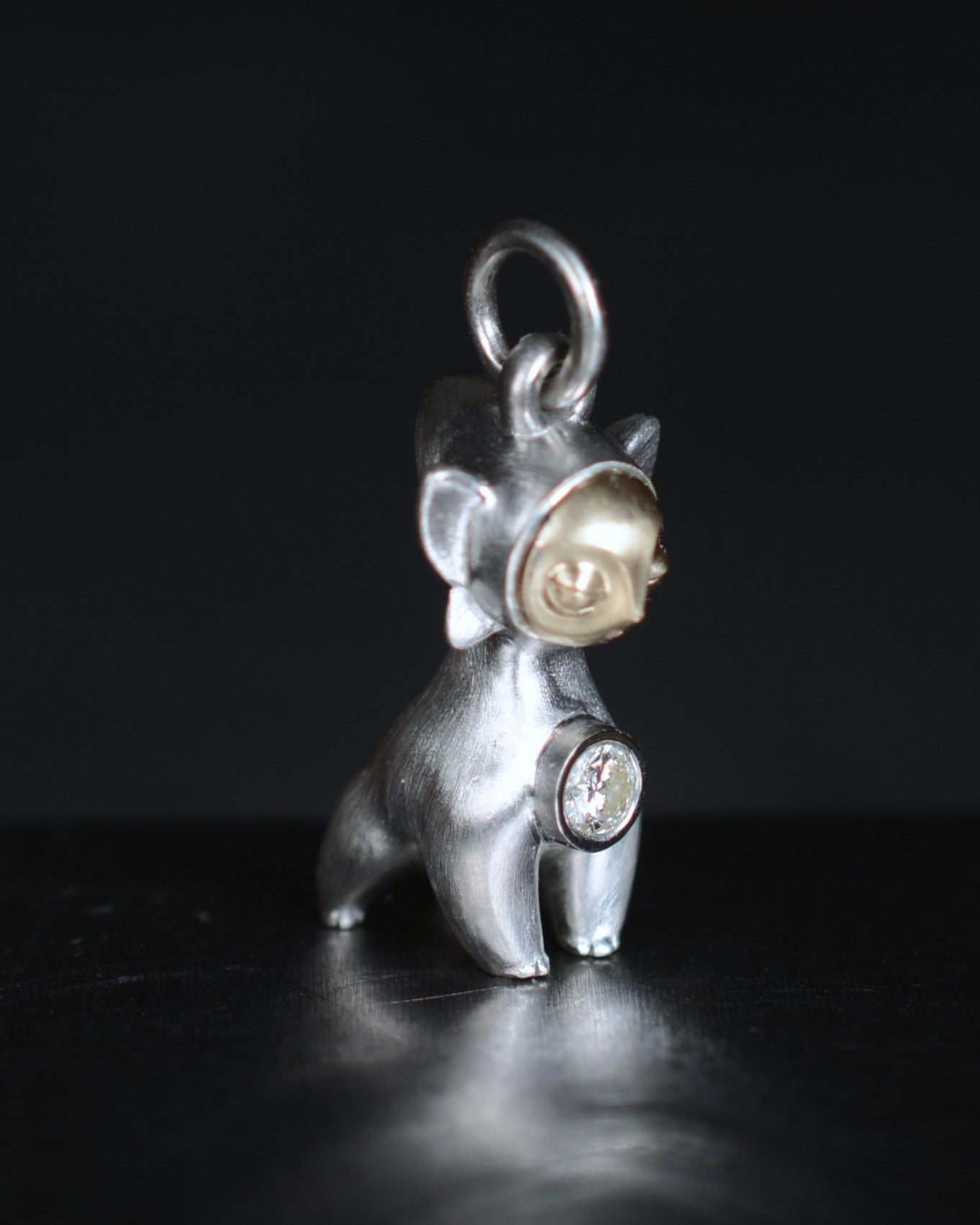 Art Deco Bright Creature with a gold face, set with a natural diamond.