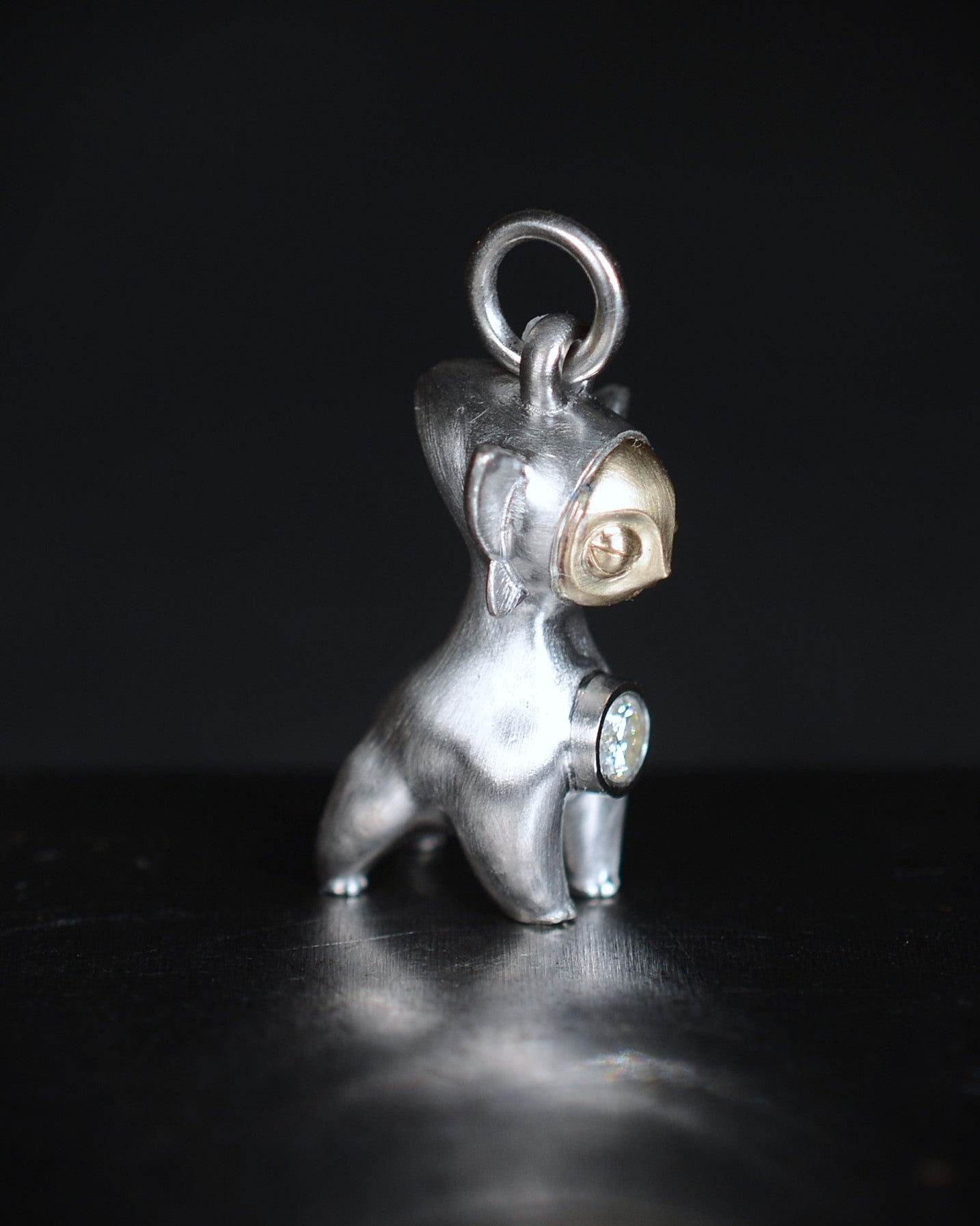 Art Deco Bright Creature with a gold face, set with a natural diamond.