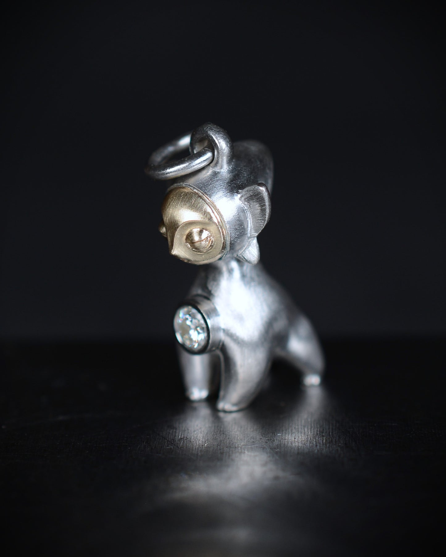 Art Deco Bright Creature with a gold face, set with a natural diamond.