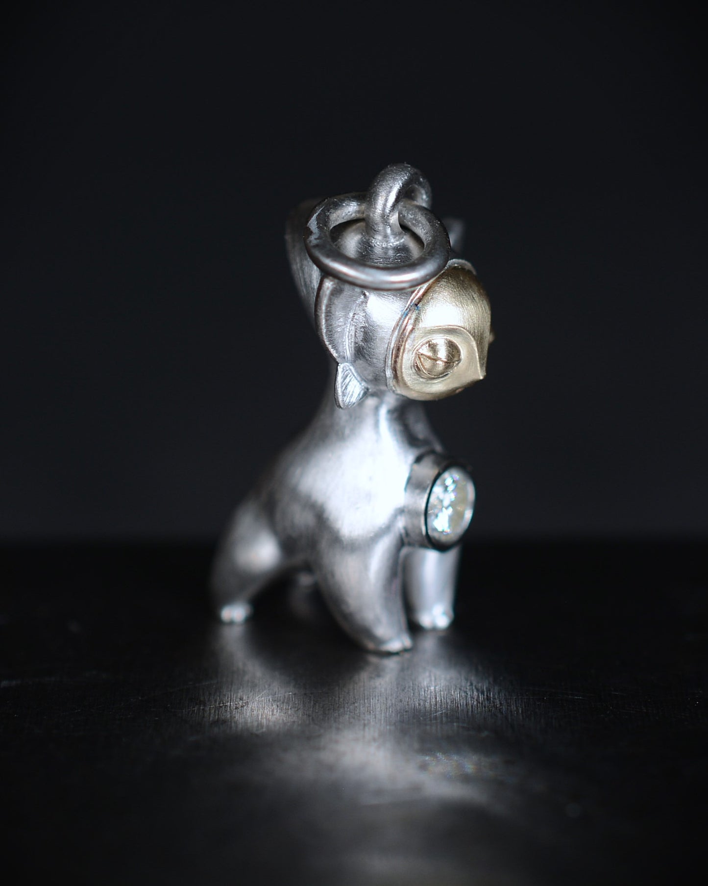 Art Deco Bright Creature with a gold face, set with a natural diamond.