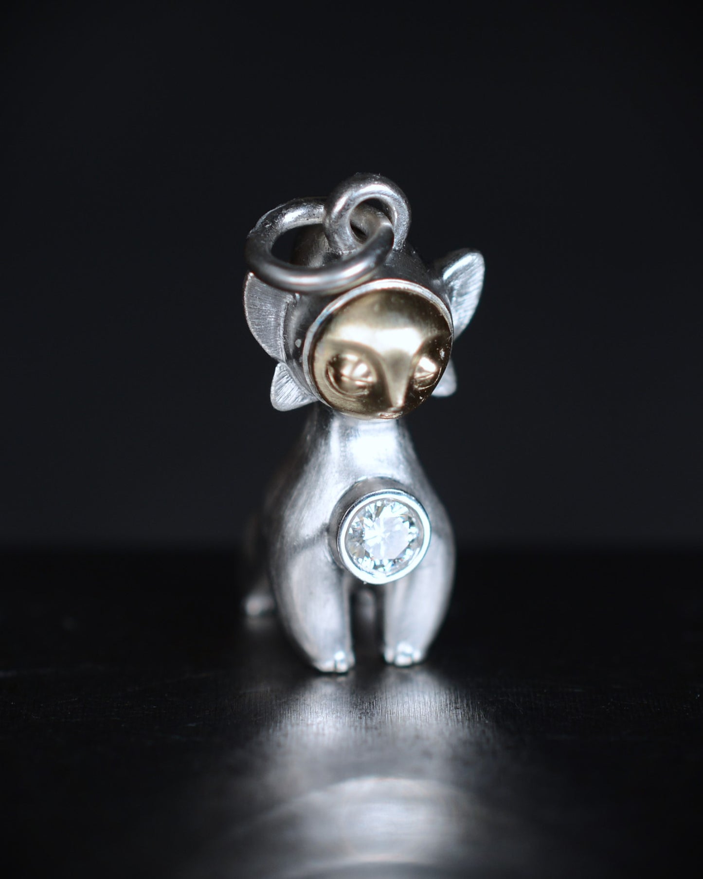 Art Deco Bright Creature with a gold face, set with a natural diamond.
