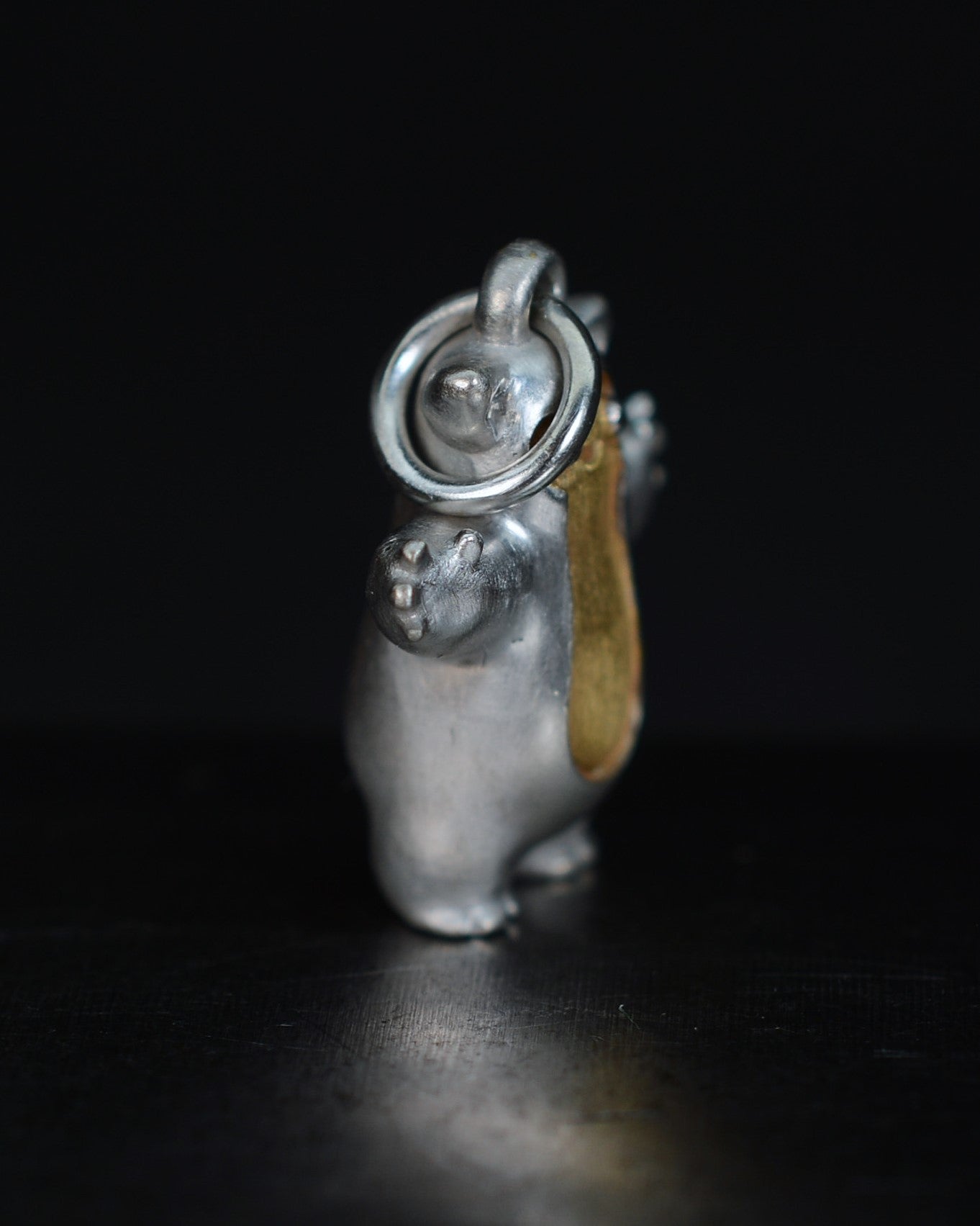 Fox eared small pearshape Bright Creature with parcel gilt.