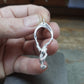 Freediver necklace. Made from highly polished, tarnish resistant silver, hung on a solid silver chain. © Adrian Ashley