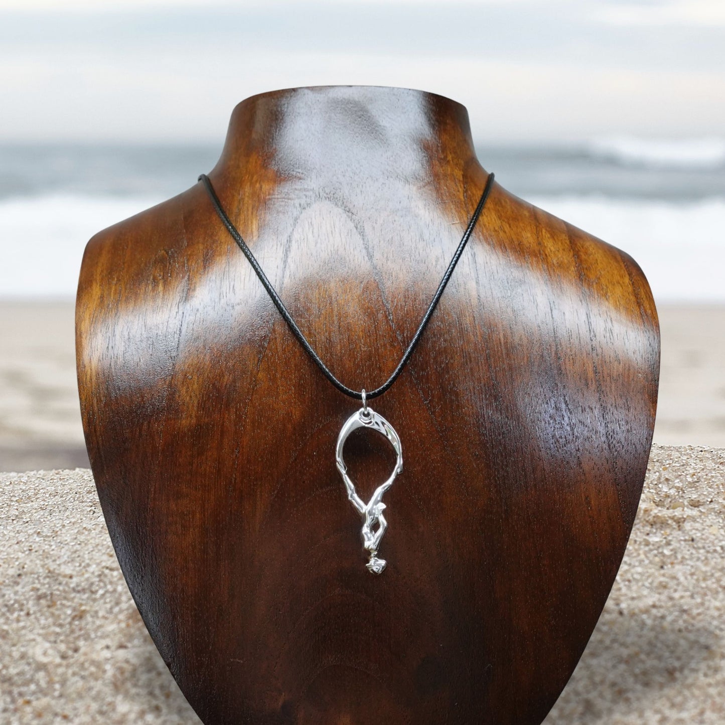 Freediver necklace. Made from highly polished, tarnish resistant silver, strung on a strong cord. © Adrian Ashley