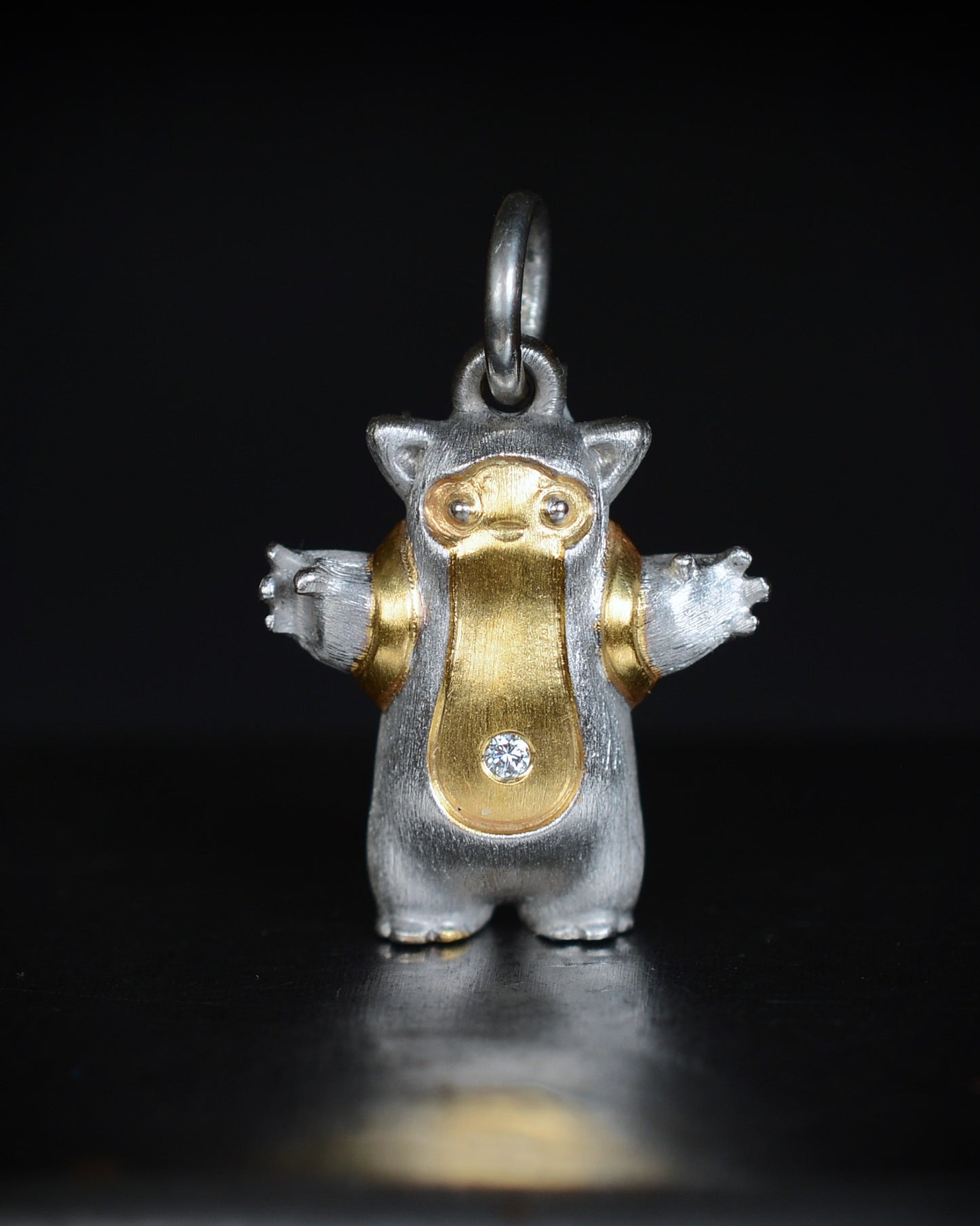 Fox eared, pear shaped, backpacker Bright Creature with a diamond and parcel gilt.