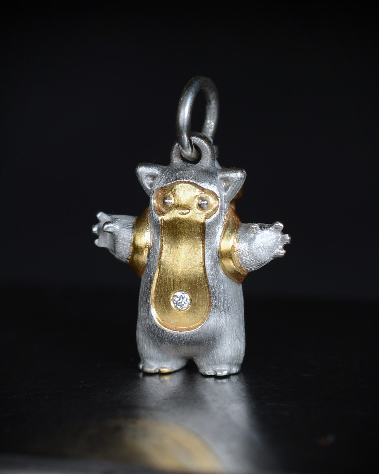 Fox eared, pear shaped, backpacker Bright Creature with a diamond and parcel gilt.