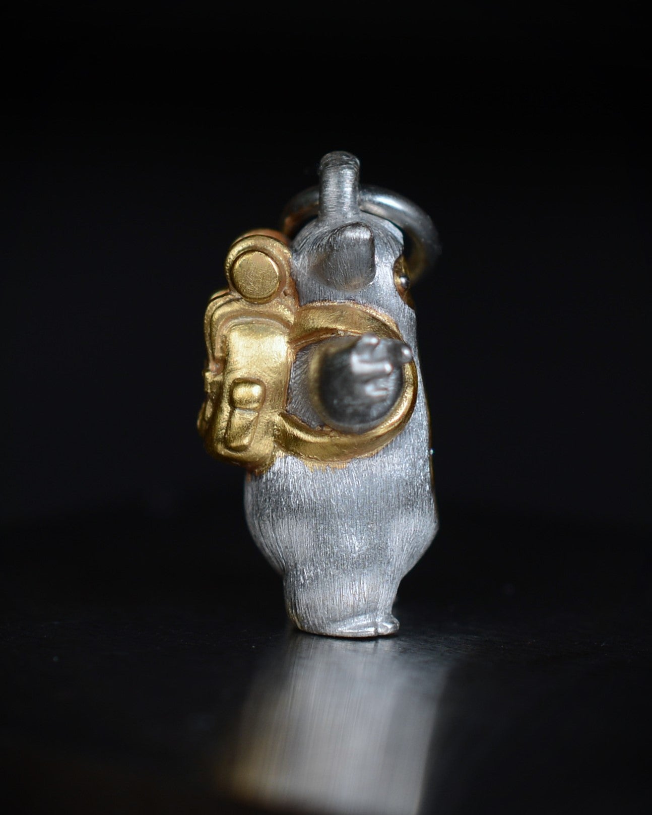 Fox eared, pear shaped, backpacker Bright Creature with a diamond and parcel gilt.