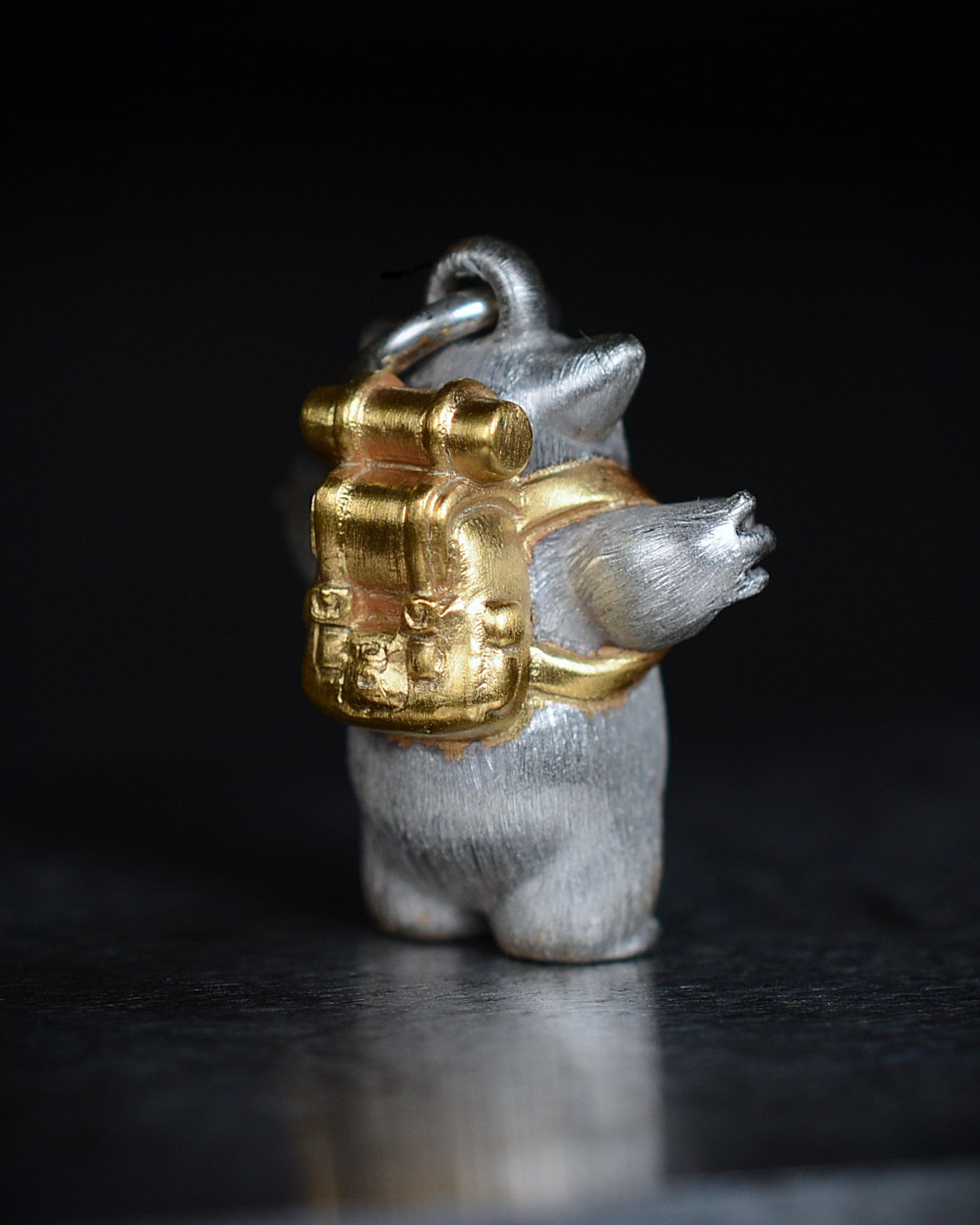 Fox eared, pear shaped, backpacker Bright Creature with a diamond and parcel gilt.