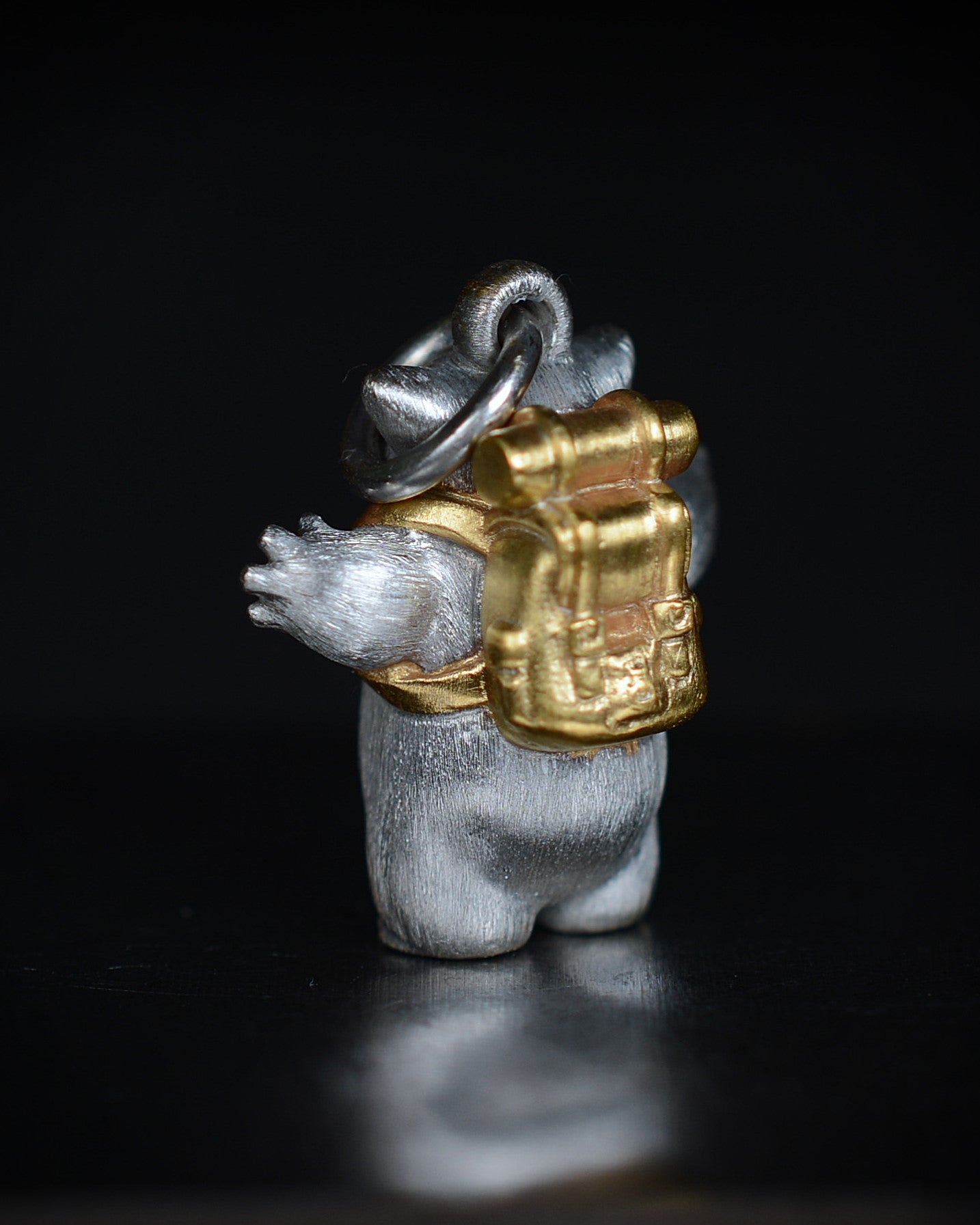 Fox eared, pear shaped, backpacker Bright Creature with a diamond and parcel gilt.